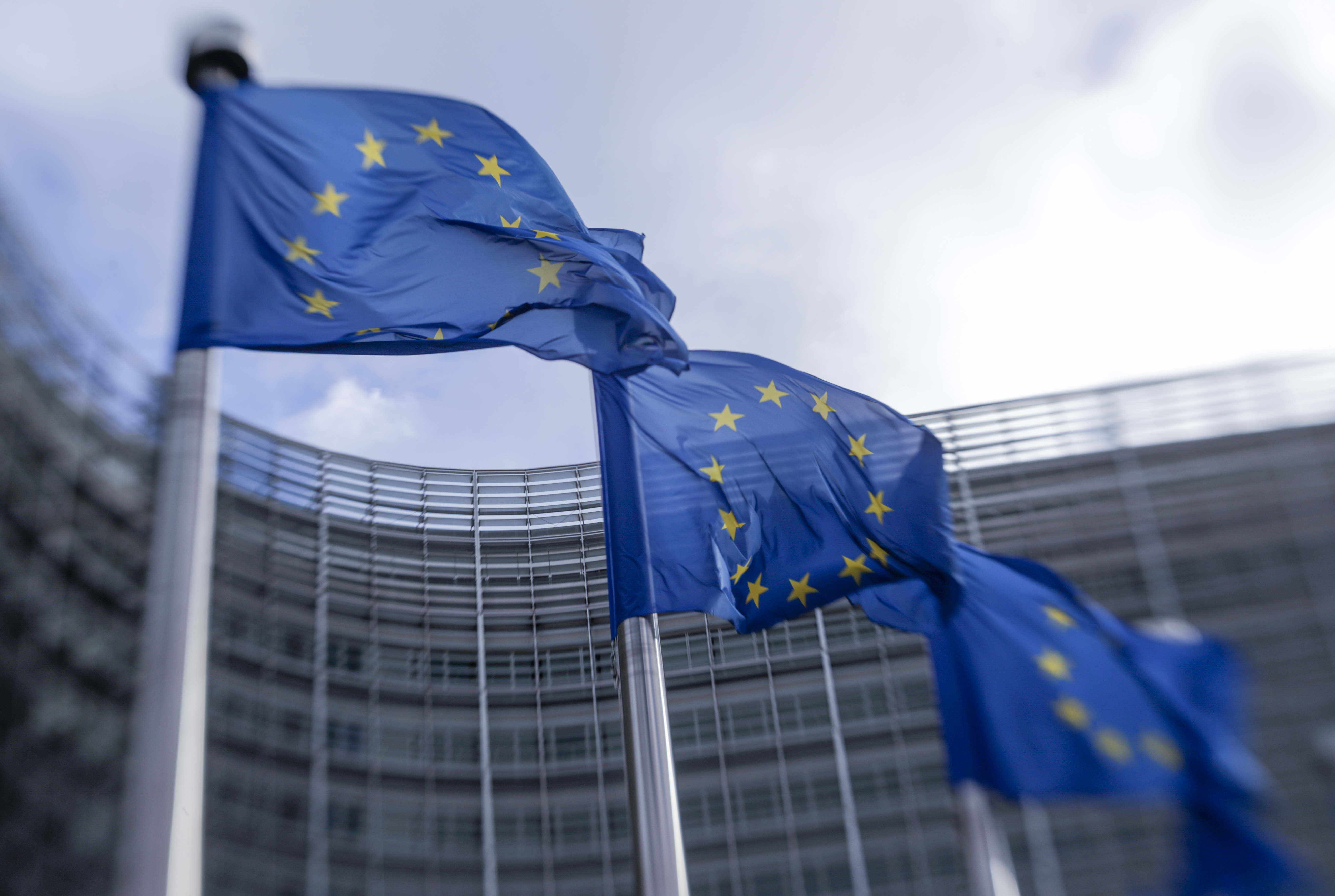 epa08795893 A picture taken with Lensbaby shows European flags in front of European Commission headquarters in Brussels, Belgium, 03 November 2020.  EPA-EFE/OLIVIER HOSLET Taken with Lensbaby