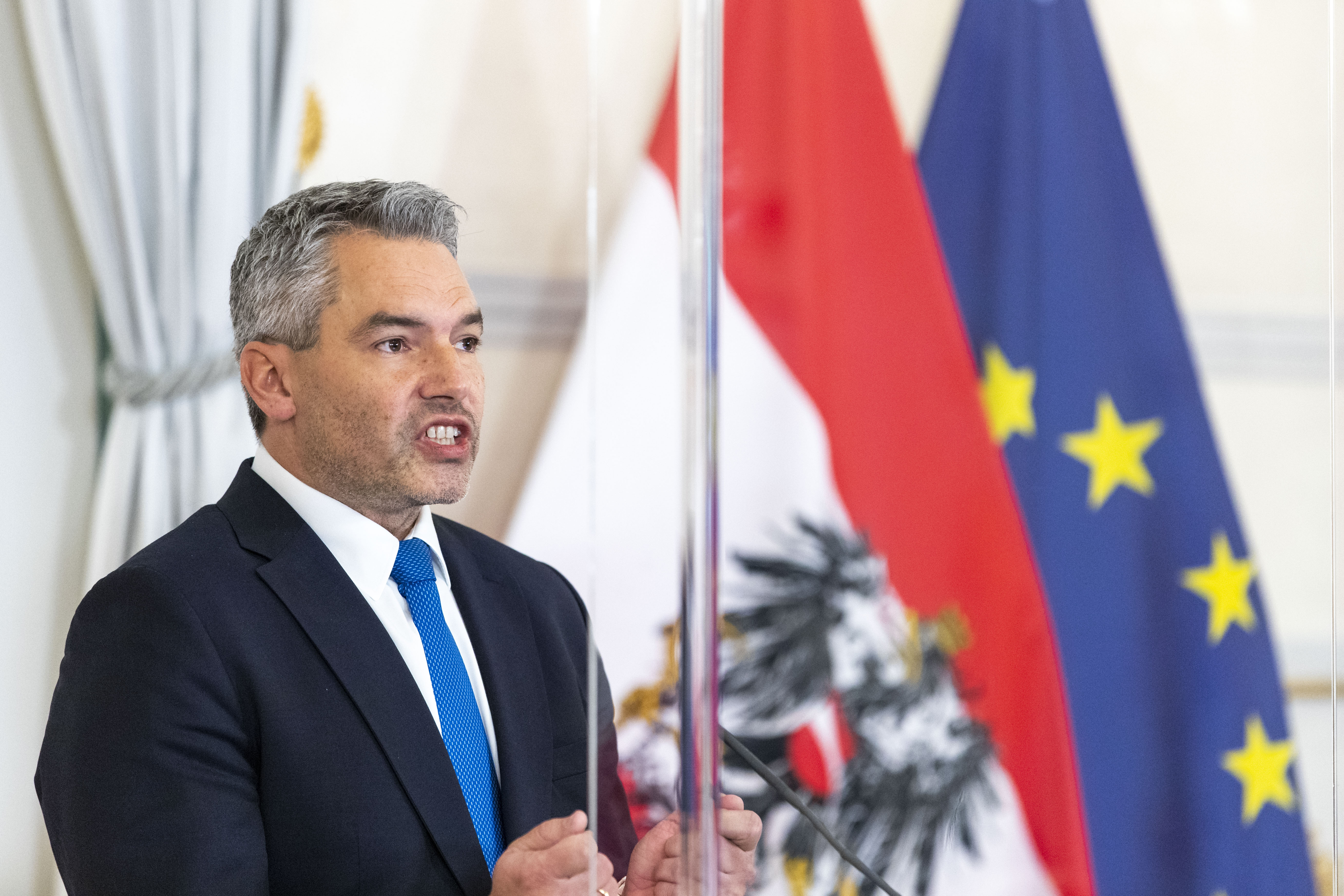 The new Austrian Chancellor Karl Nehammer speaks at a news conference about his plans for the upcoming weeks in Vienna, Austria, Tuesday, Dec. 7, 2021. (AP Photo/Lisa Leutner)