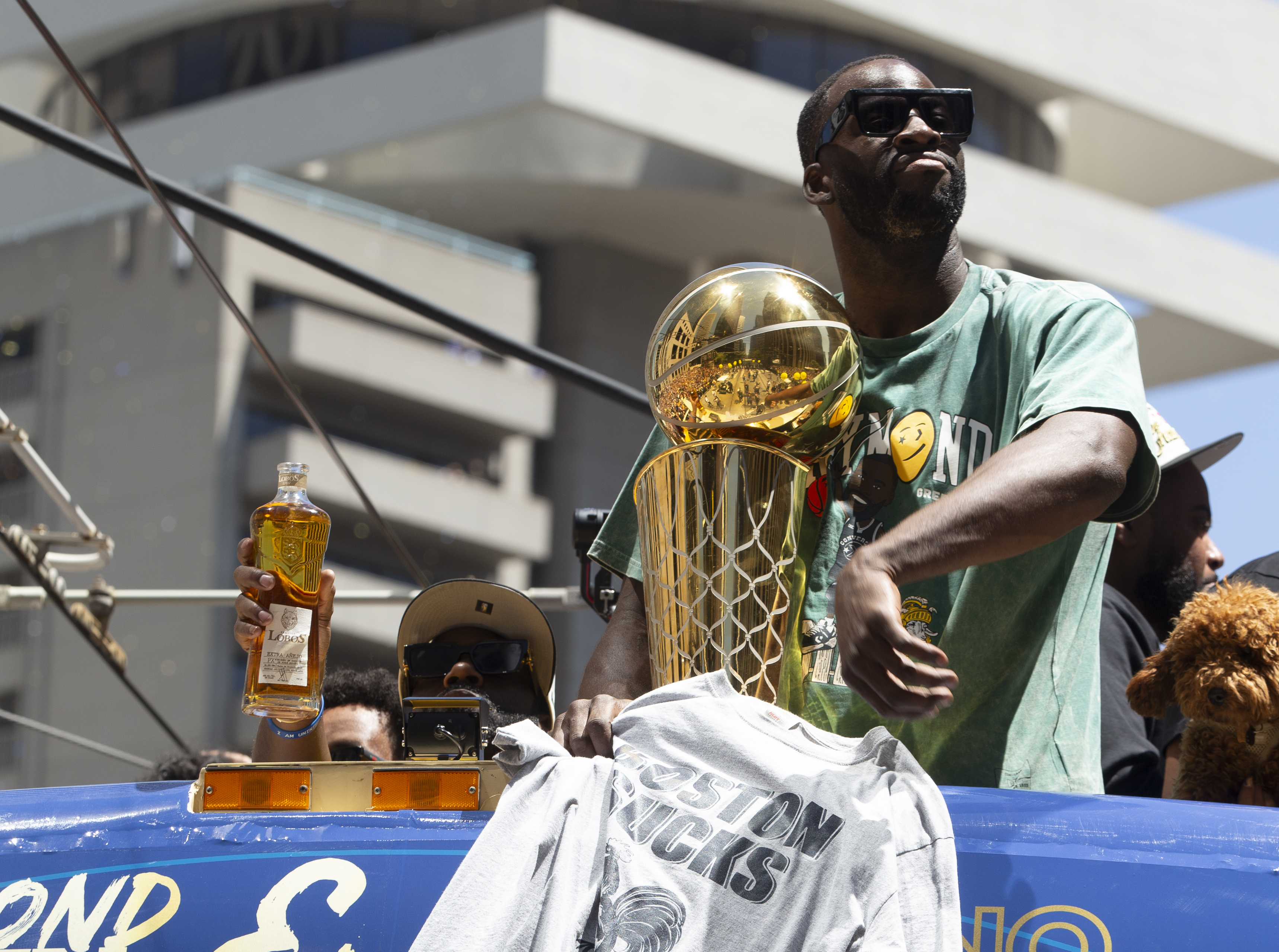 epa10024500 Golden State Warrior forward Draymond Green holds up a 'Boston Sucks' t-shirt during a parade for the NBA Champion Golden State Warriors in San Francisco, California, USA, 20 June 2022.  EPA-EFE/D. ROSS CAMERON  SHUTTERSTOCK OUT