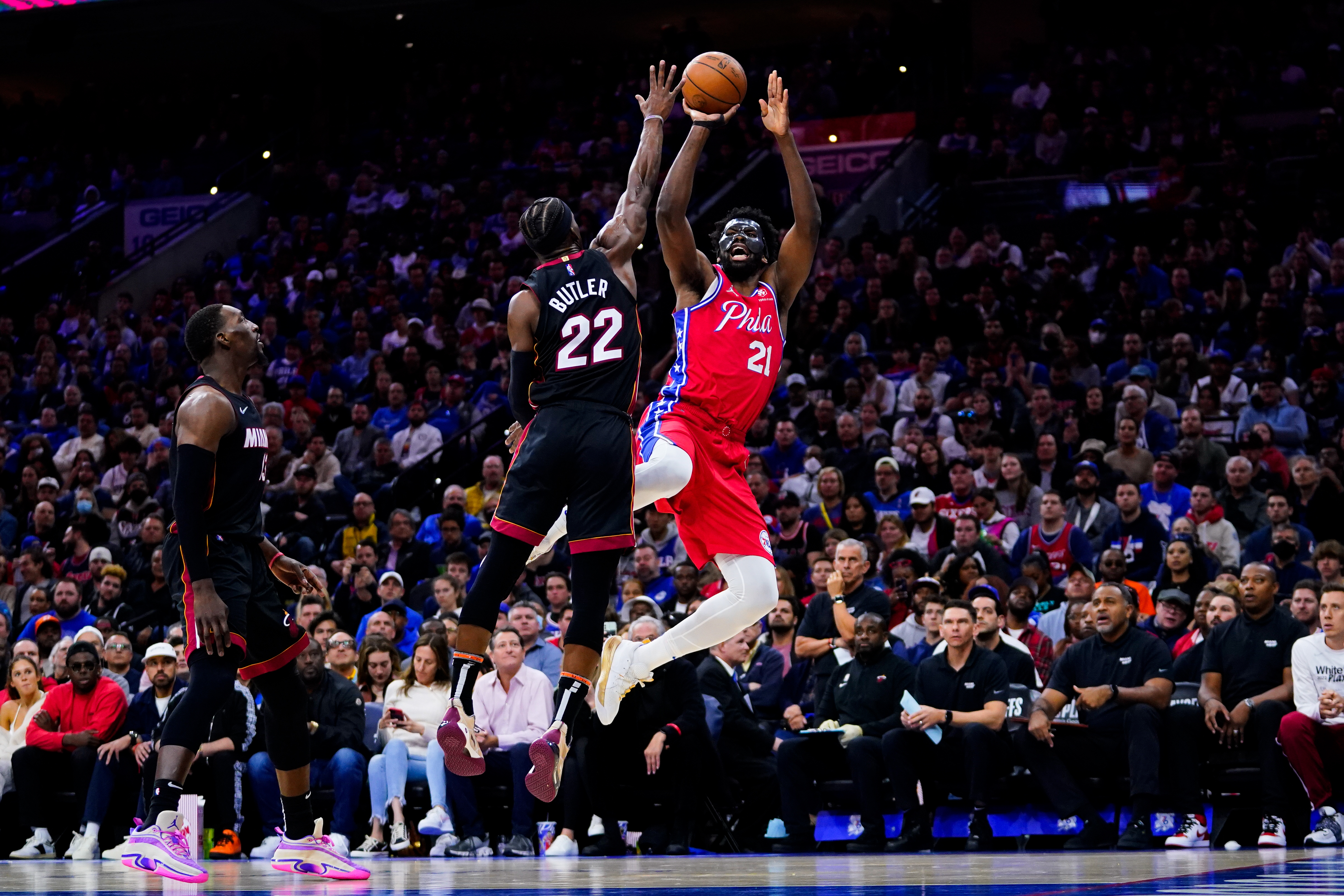Philadelphia 76ers' Joel Embiid (21) goes up for a shot against Miami Heat's Jimmy Butler (22) during the second half of Game 4 of an NBA basketball second-round playoff series, Sunday, May 8, 2022, in Philadelphia. (AP Photo/Matt Slocum)