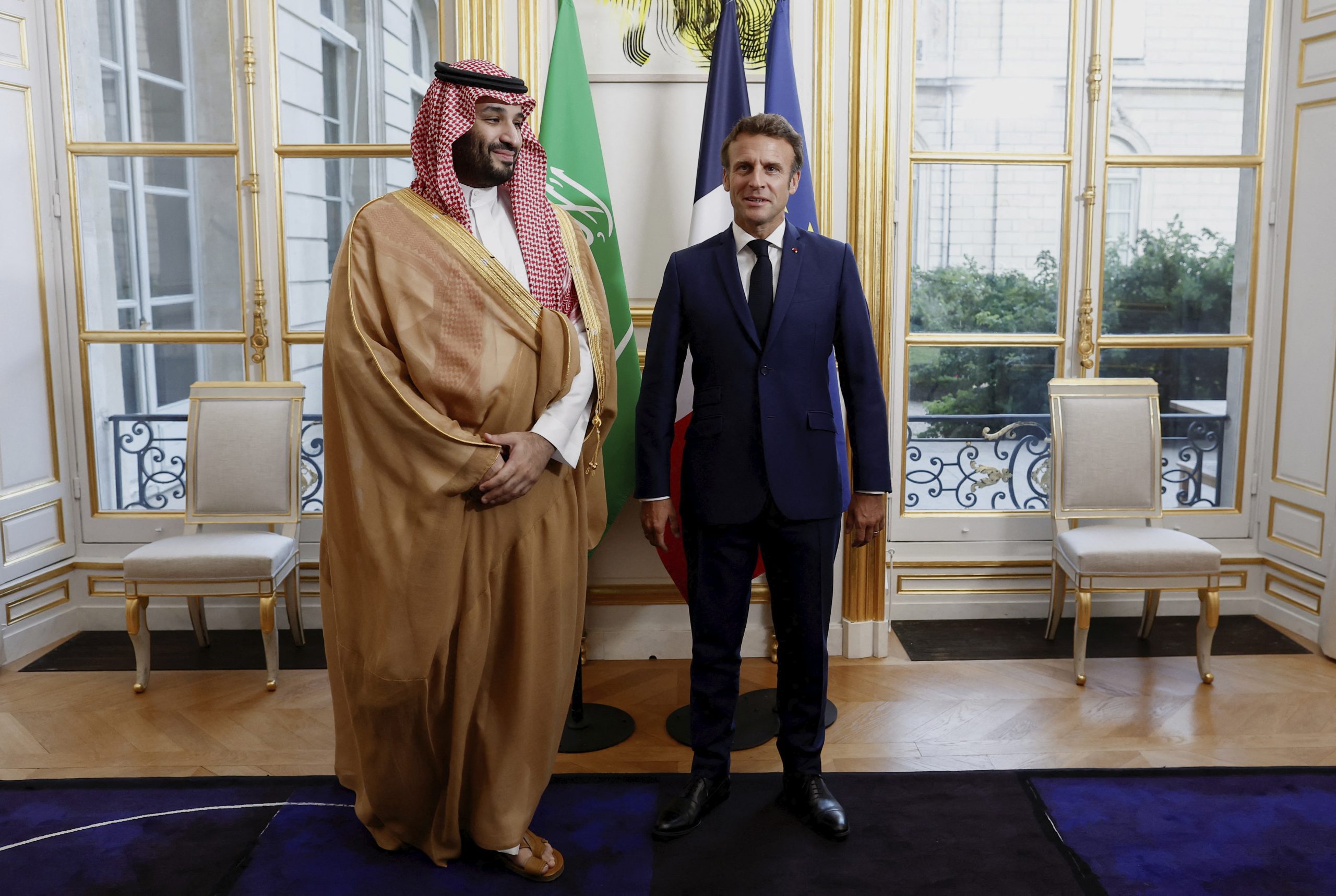 French President Emmanuel Macron welcomes Saudi Crown Prince Mohammed bin Salman for a dinner inside the Elysee Palace in Paris, Thursday July 28, 2022. (Benoit Tessier/Pool via AP)