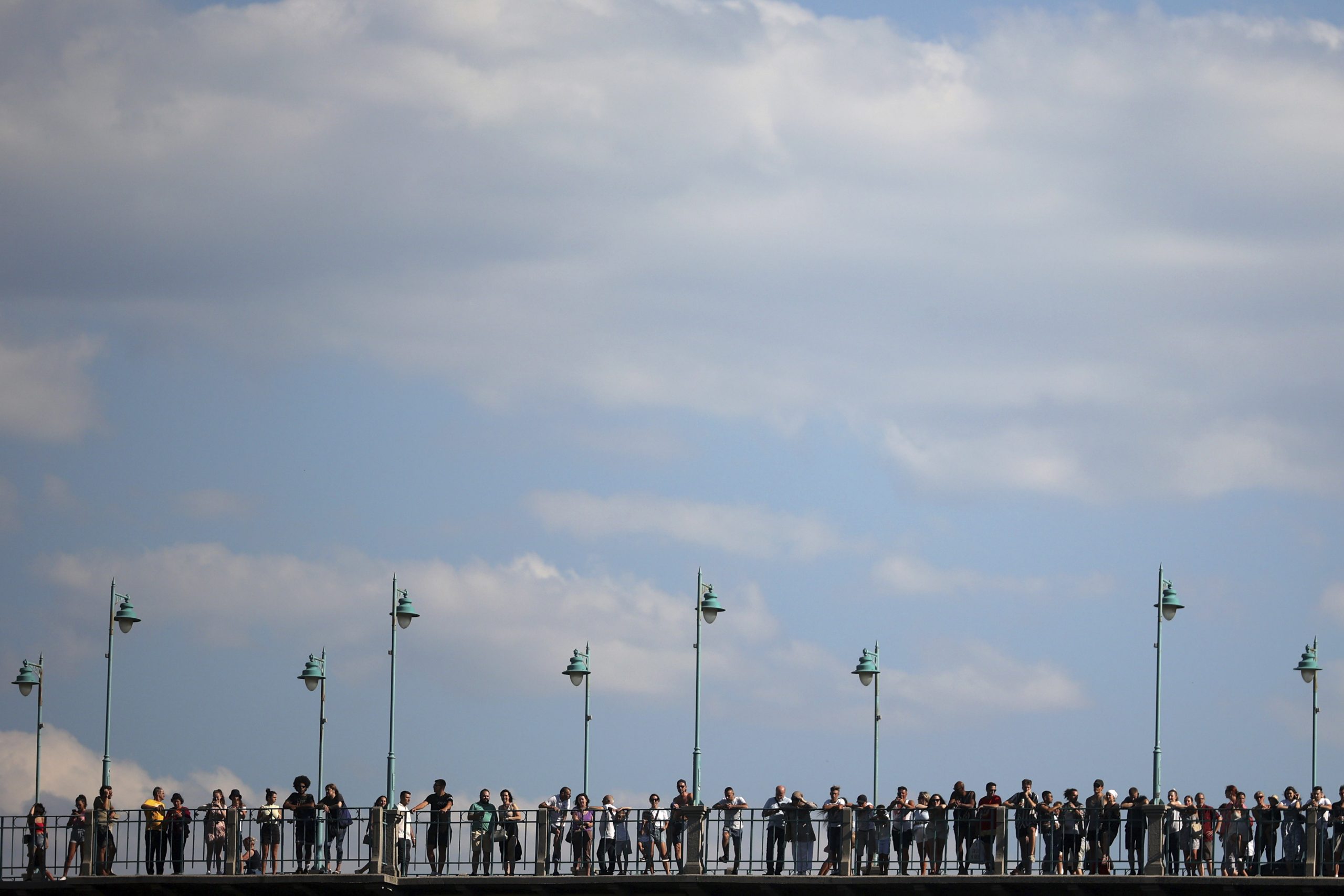 People watch the 456th traditional annual high diving competition in Mostar, Bosnia, Sunday, July 31, 2022. A total of 31 divers from Bosnia and region leapt from the 23-meter-high bridge into the Neretva River. (AP Photo/Armin Durgut)