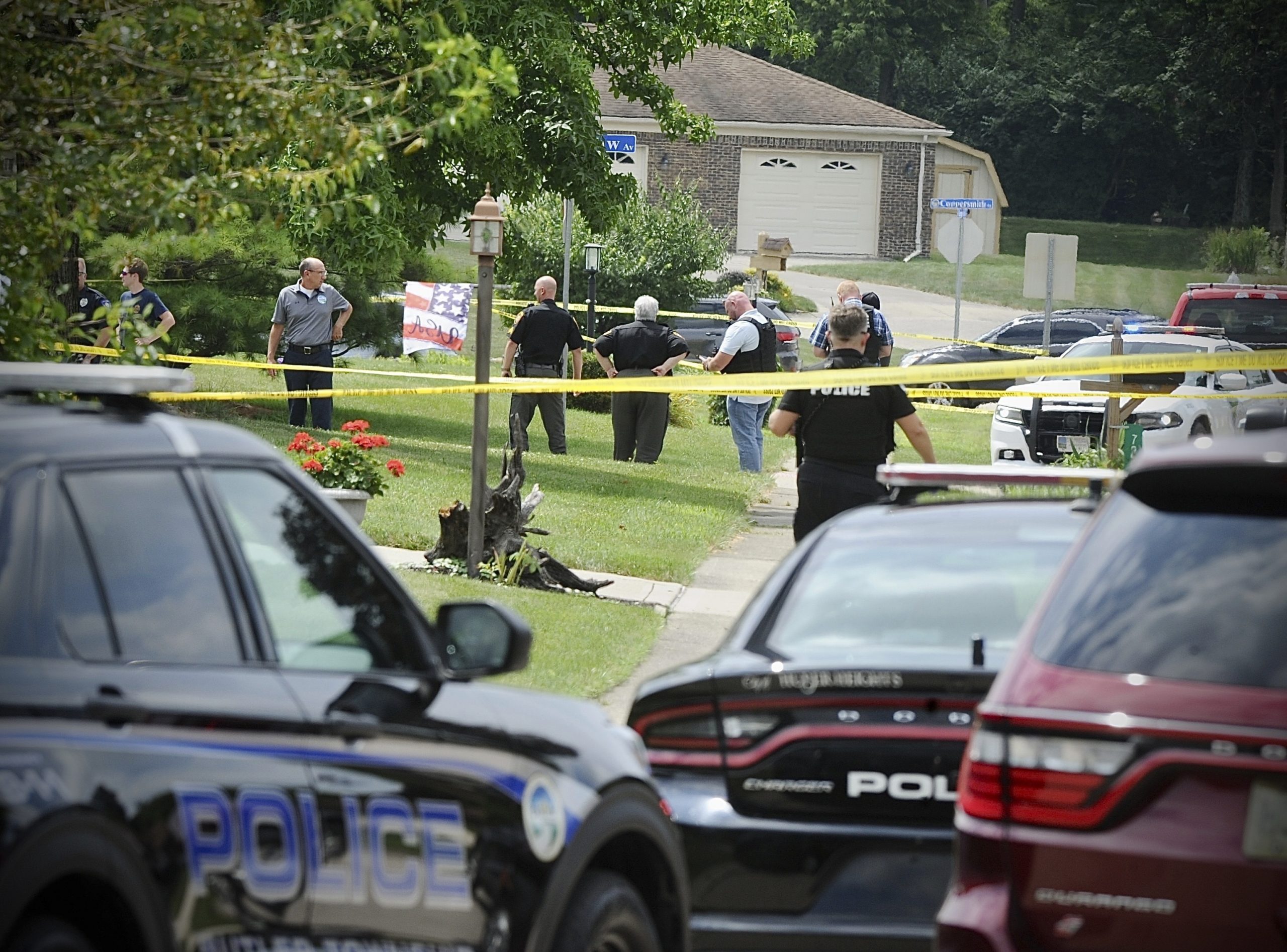 Police investigate a shooting Friday, Aug. 5, 2022, in Butler Township, Ohio.  Authorities say four people were shot to death in the Ohio suburb and a man considered armed and dangerous is being sought. (Marshall Gorby /Dayton Daily News via AP)
