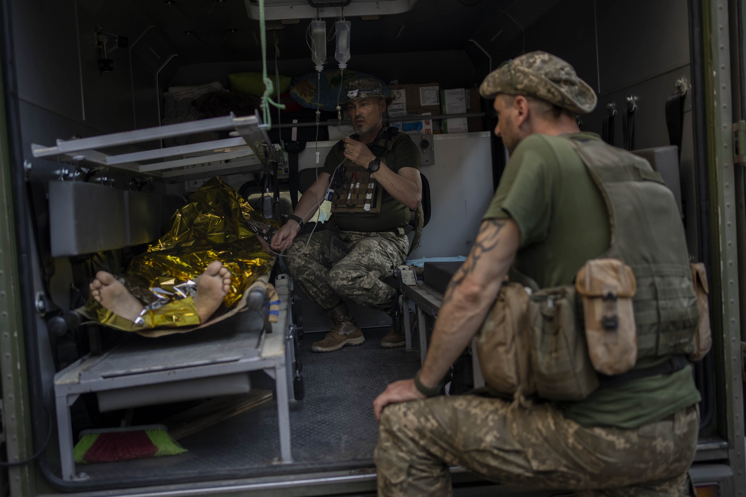 An injured Ukrainian servicemen is transferred to a medical facility after getting an emergency medical treatment in Bakhmut, eastern Ukraine, Tuesday, June 7, 2022. (AP Photo/Bernat Armangue)