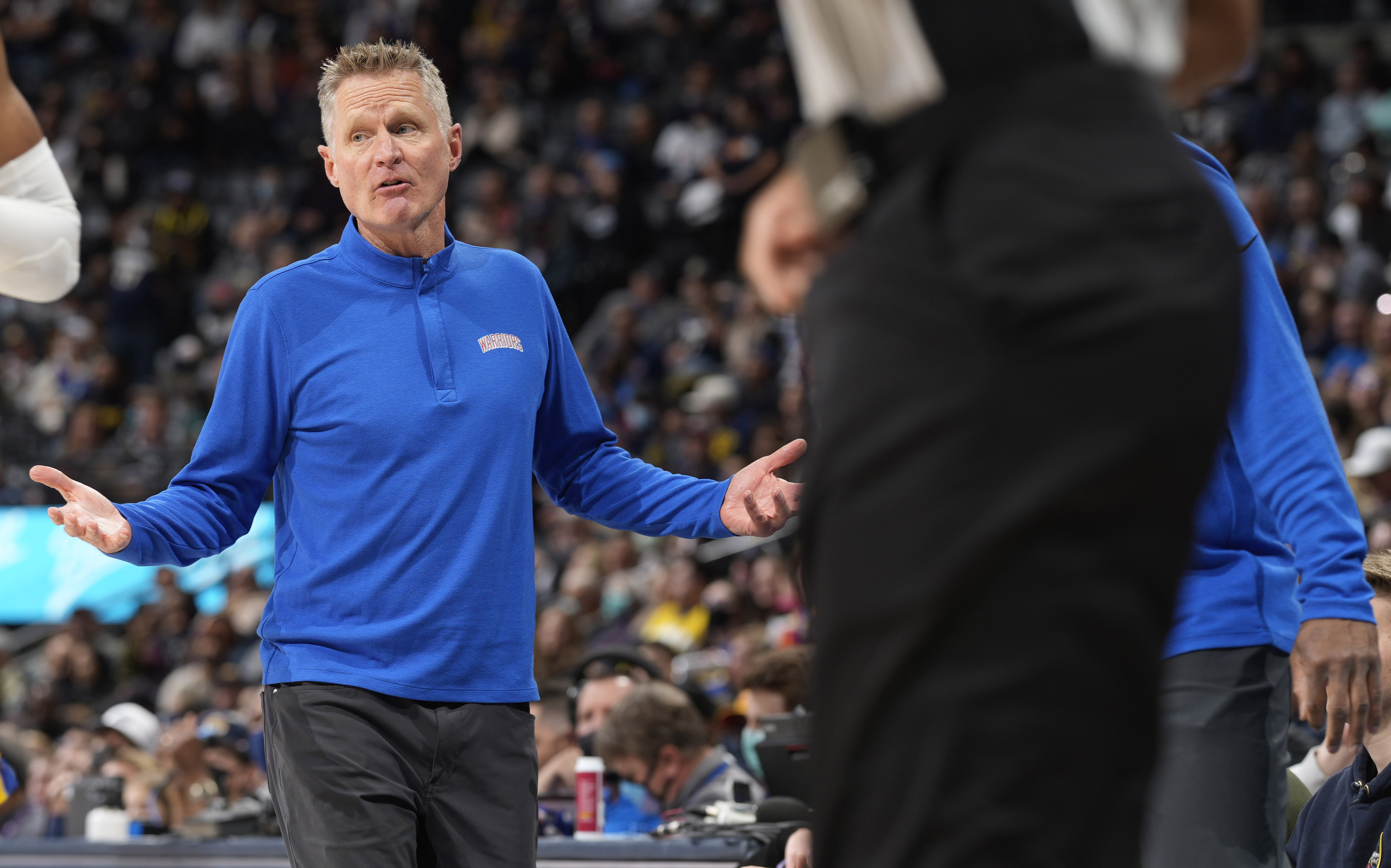 Golden State Warriors head coach Steve Kerr, left, argues for a call in the first half of an NBA basketball game against the Denver Nuggets, Monday, March 7, 2022, in Denver. (AP Photo/David Zalubowski)