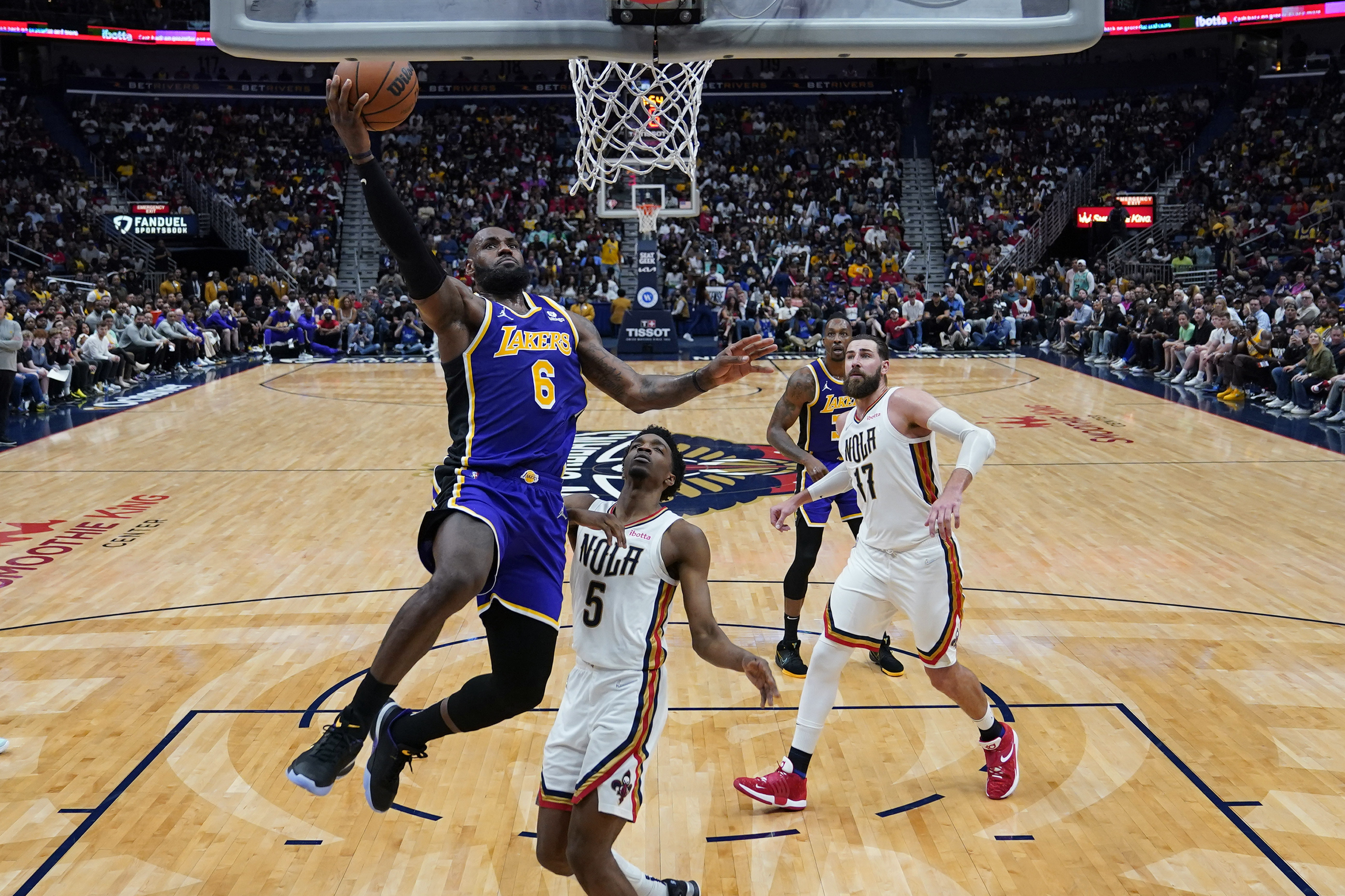 Los Angeles Lakers forward LeBron James (6) goes to the basketagaisnt New Orleans Pelicans forward Herbert Jones (5) in the second half of an NBA basketball game in New Orleans, Sunday, March 27, 2022. The Pelicans won 116-108. (AP Photo/Gerald Herbert)