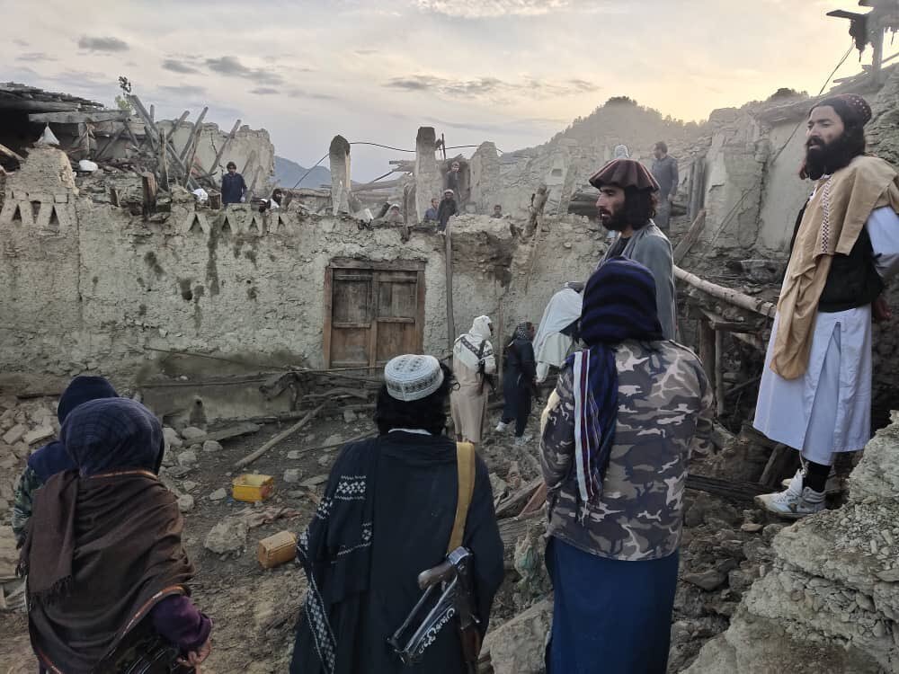 In this photo released by a set-run news agency Bakhtar, Afghans look at destruction caused by an earthquake in the province of Paktika, eastern Afghanistan, Wednesday, June 22, 2022. (Bakhtar News Agency via AP)