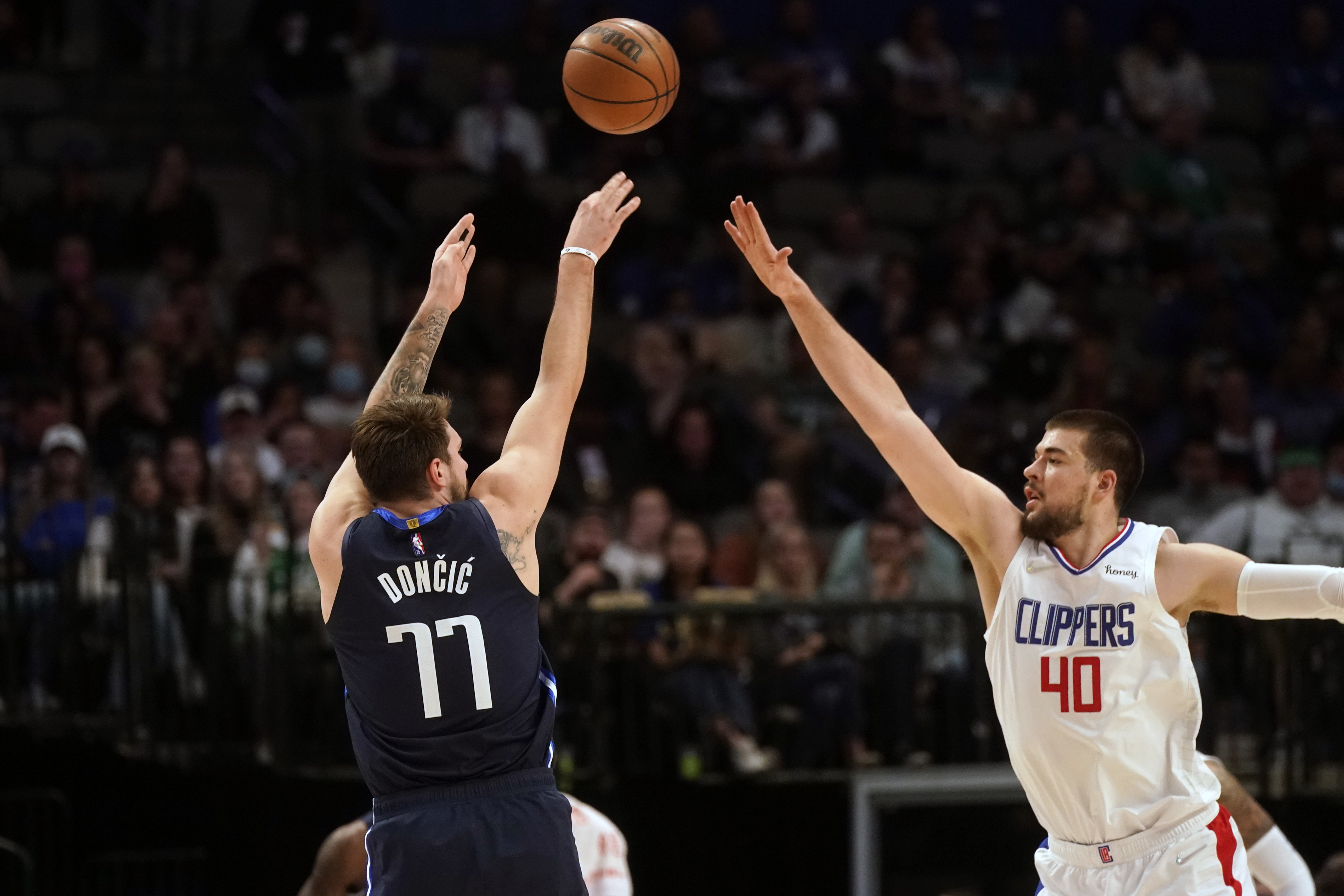 Los Angeles Clippers center Ivica Zubac (40) tries to block a shot by Dallas Mavericks guard Luka Doncic (77) during the first quarter of an NBA basketball game in Dallas, Thursday, Feb. 10, 2022. (AP Photo/LM Otero)