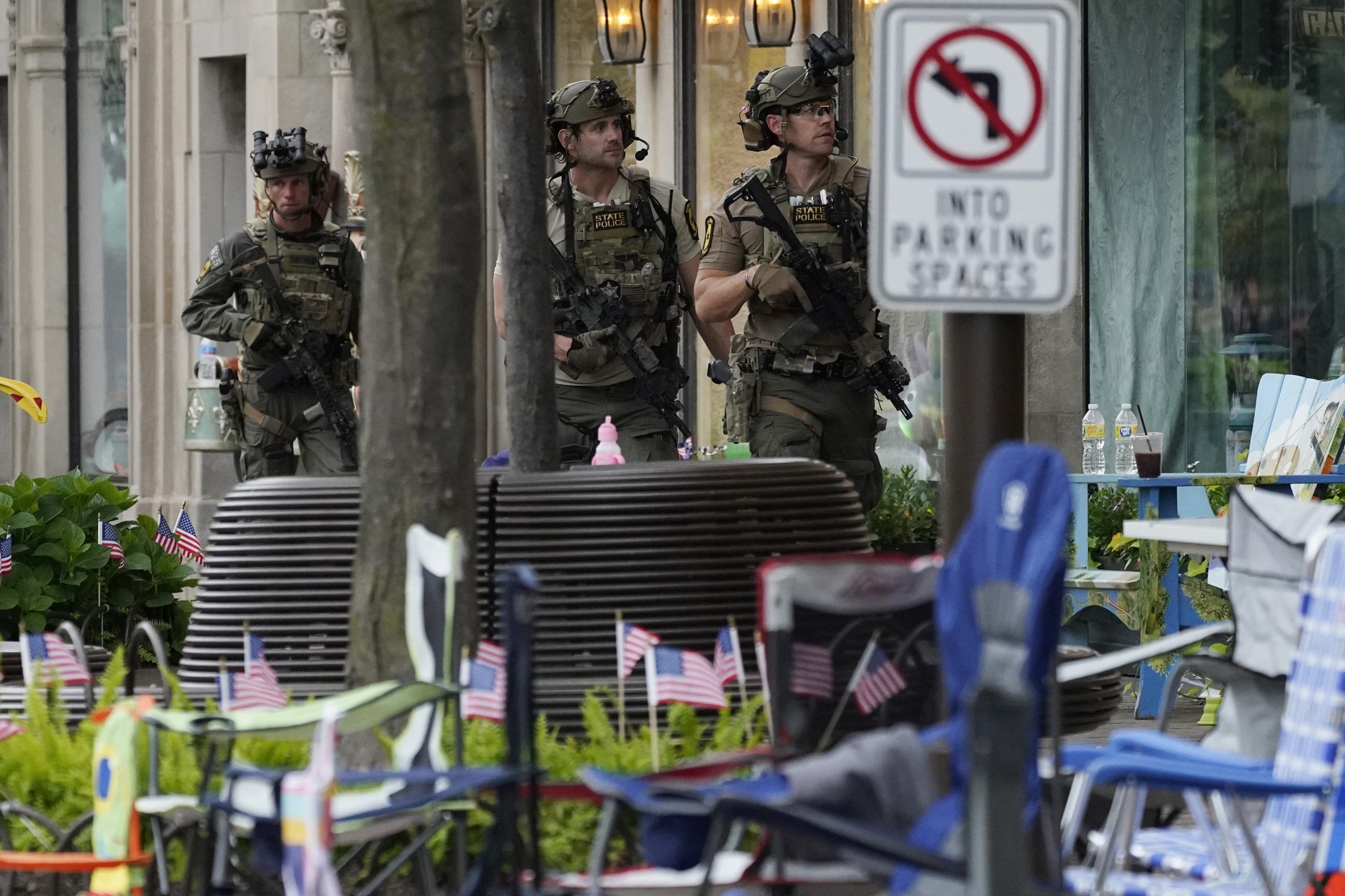 Law enforcement search after a mass shooting at the Highland Park Fourth of July parade in downtown Highland Park, Ill., a Chicago suburb on Monday, July 4, 2022. (AP Photo/Nam Y. Huh)