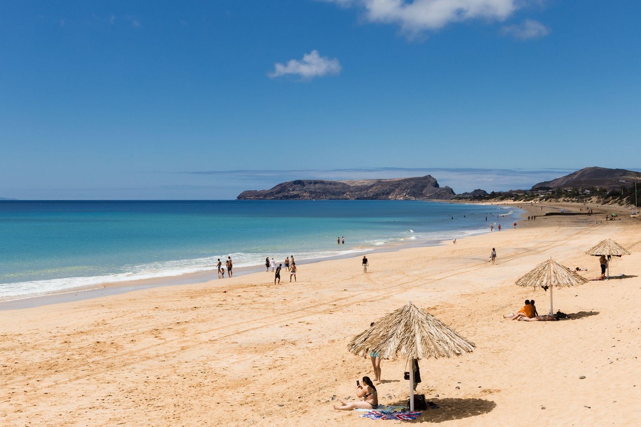 Porto Santo, Madeira, Portugal - June 2020:: Tourists and locals taking a bath on "Porto Santo" island beach.