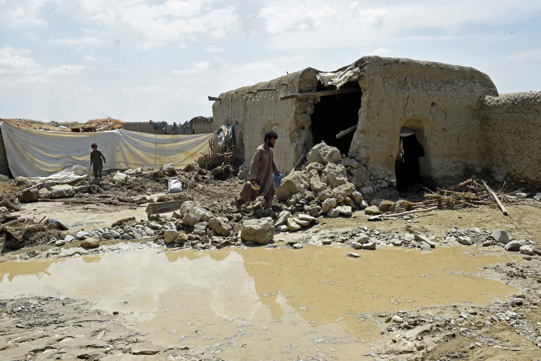 Flood affected residents clear debris after the dam in Pishin district of Balochistan broke due to heavy rains on July 7, 2022.,Image: 705757777, License: Rights-managed, Restrictions: , Model Release: no, Credit line: Banaras KHAN / AFP / Profimedia