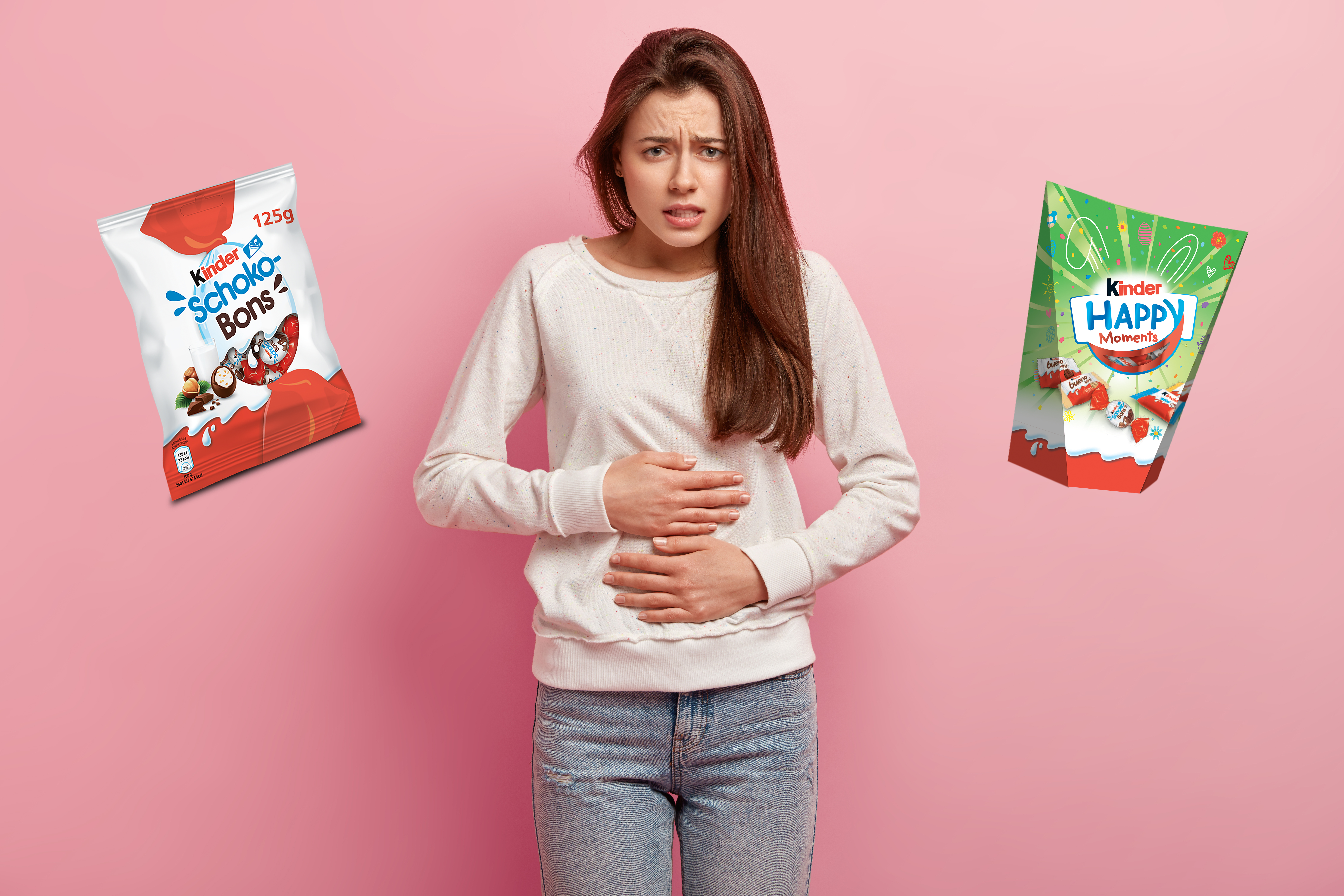 Kinder salmonela kombo Upset European woman keeps hands on belly, suffers from pain, feels discomfort after eating fast food, wears casual white jumper, isolated over pink background. People, illness, cramps concept