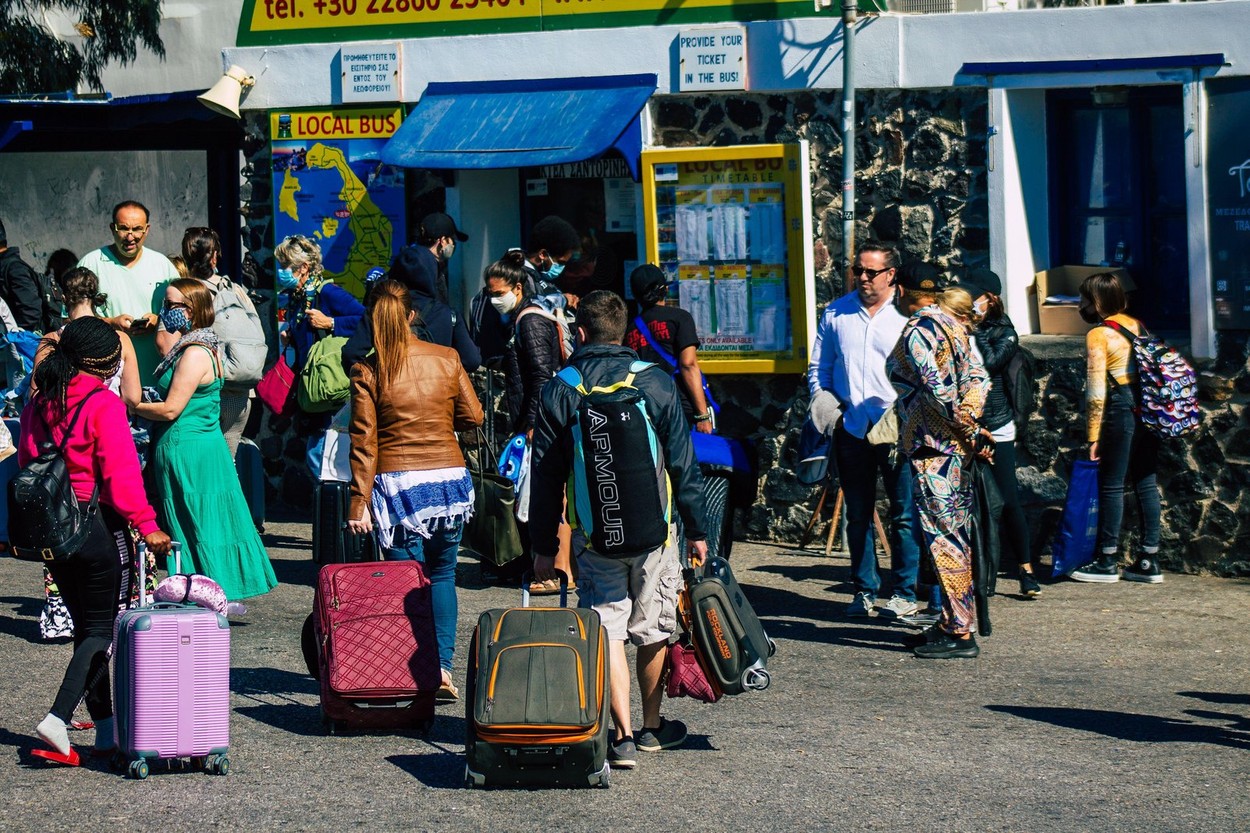 Santorini, Fira, Greece - October 20, 2021 Crowd of tourists at the bus station, all the buses depart and finish their routes,  6 destinations includi