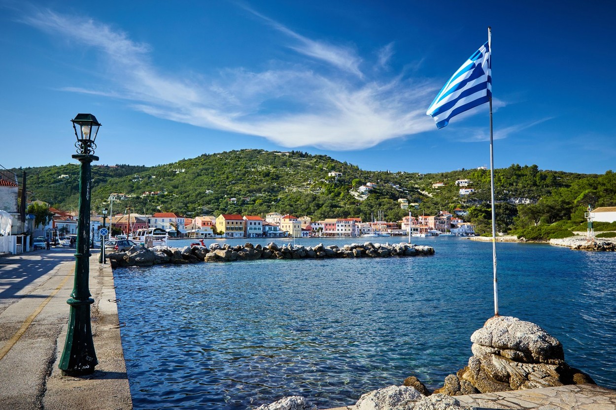 Greek flag at the port. Islands of Paxos Greece.
