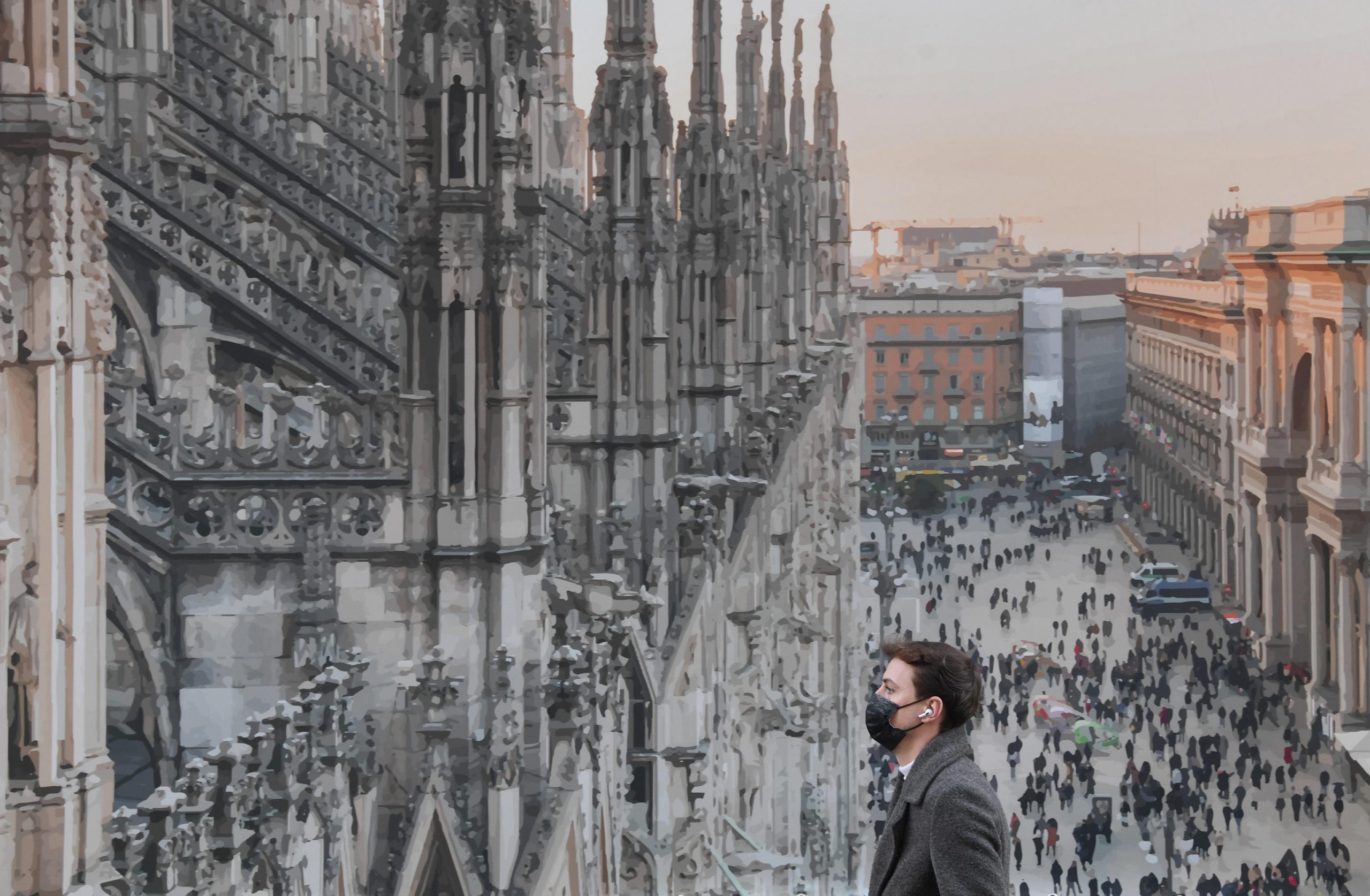 epa08883806 A person wearing a face mask walks by a poster of piazza Duomo (Cathedral square) and set up in the central area of Milan, Italy, 14 December 2020.  EPA-EFE/Daniel Dal Zennaro
