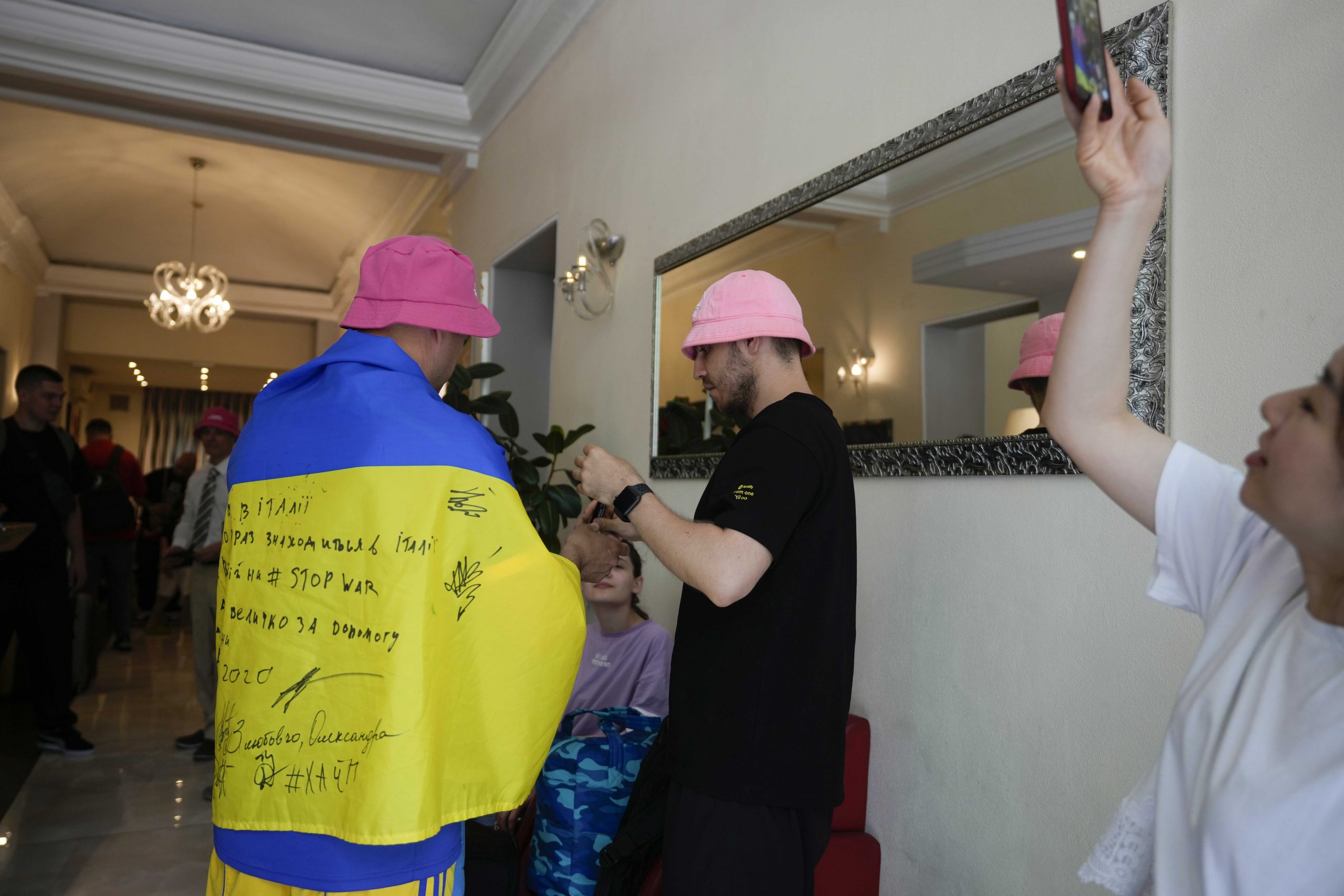 Oleh Psiuk, frontman of Ukraine's Kalush Orchestra, signs autographs before leaving Universo Hotel, after winning the Grand Final of the Eurovision Song Contest, in Turin, Italy, Sunday, May 15, 2022. (AP Photo/Luca Bruno)