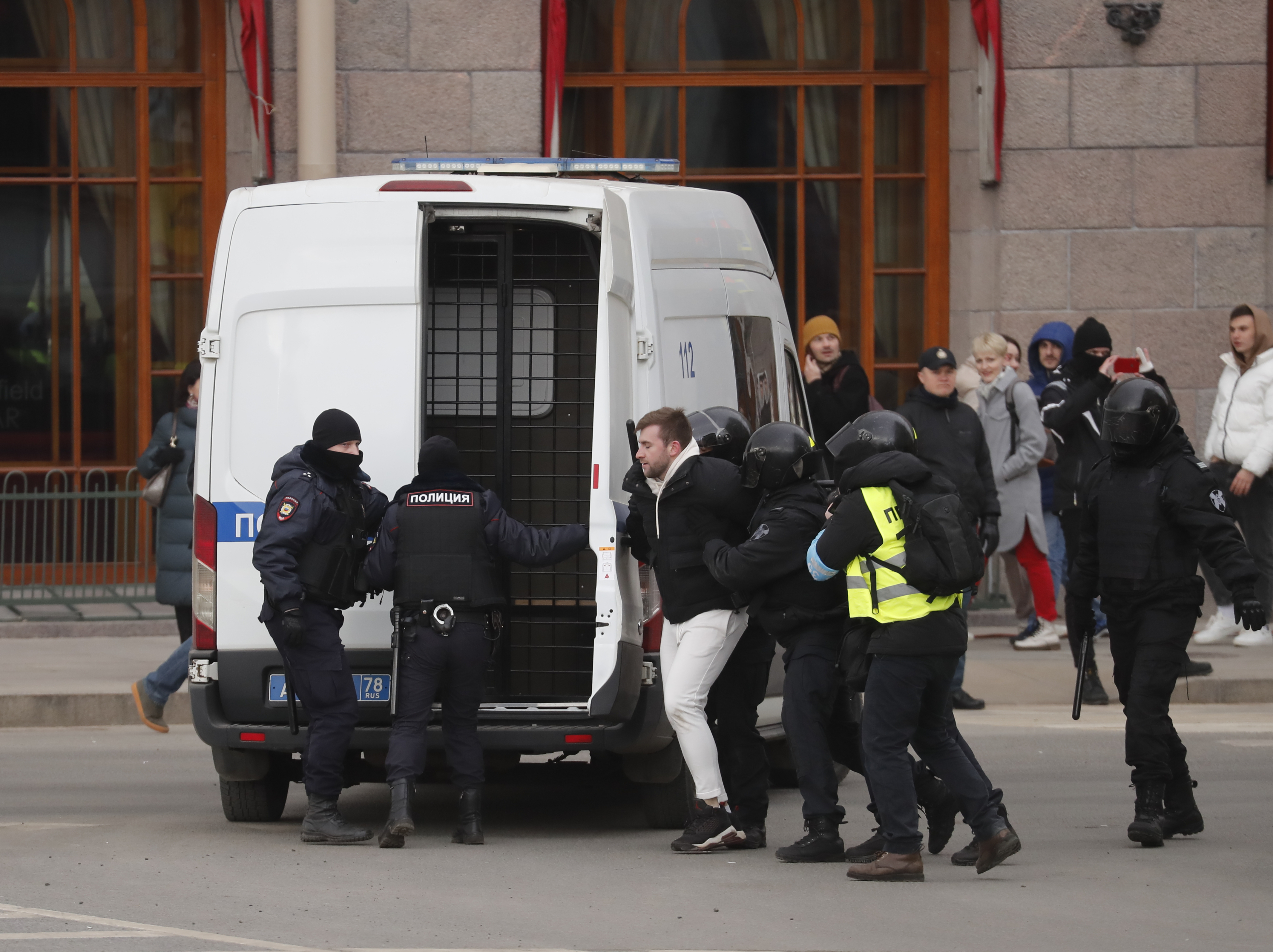 Russian policemen detain protestors during rally against entry of Russian troops into Ukraine
