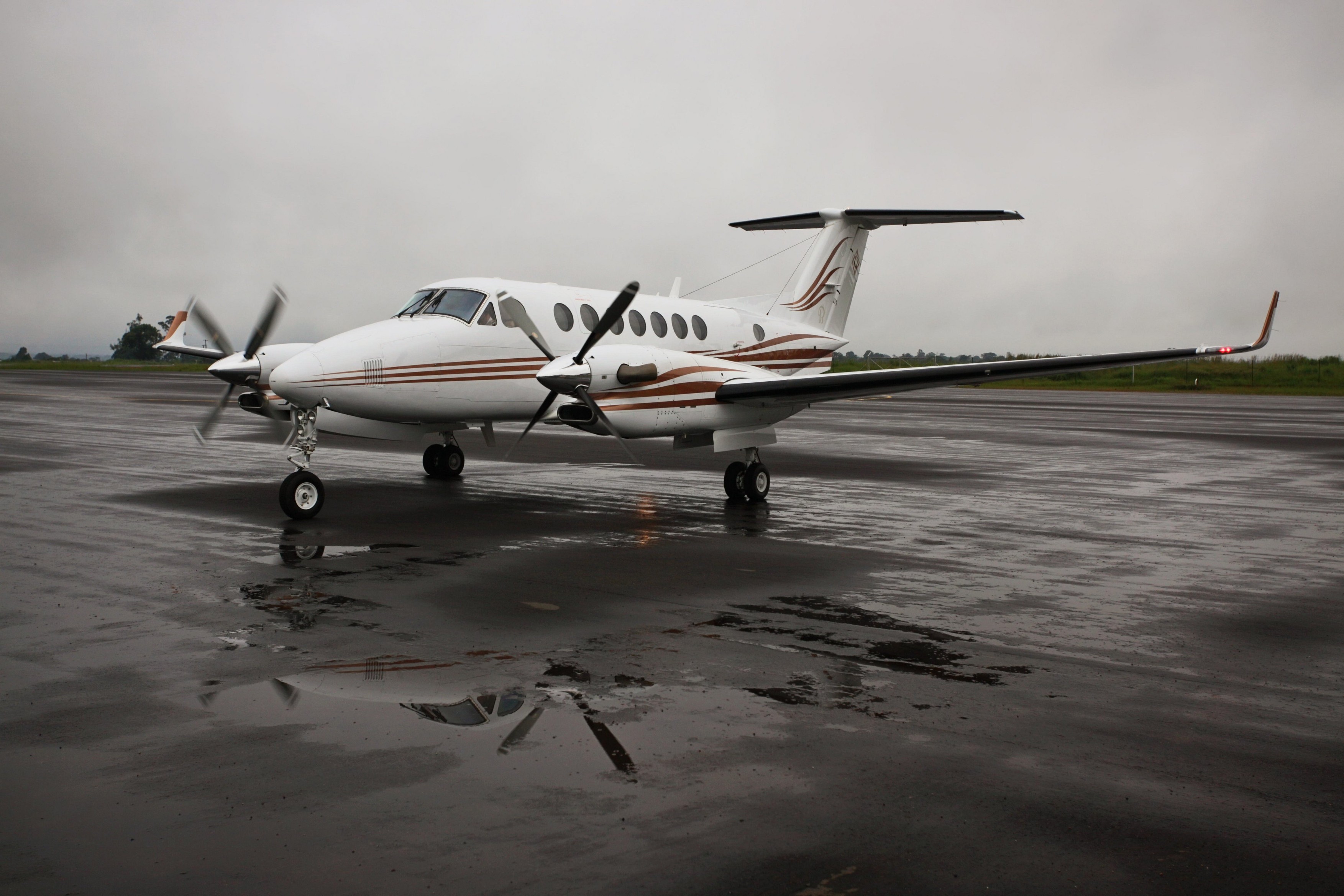 First Quantum Beechcraft twin engine turboprop plane on a wet Solwezi airstrip,Image: 160331459, License: Rights-managed, Restrictions: , Model Release: no, Credit line: Blaize Pascall / Alamy / Alamy / Profimedia
