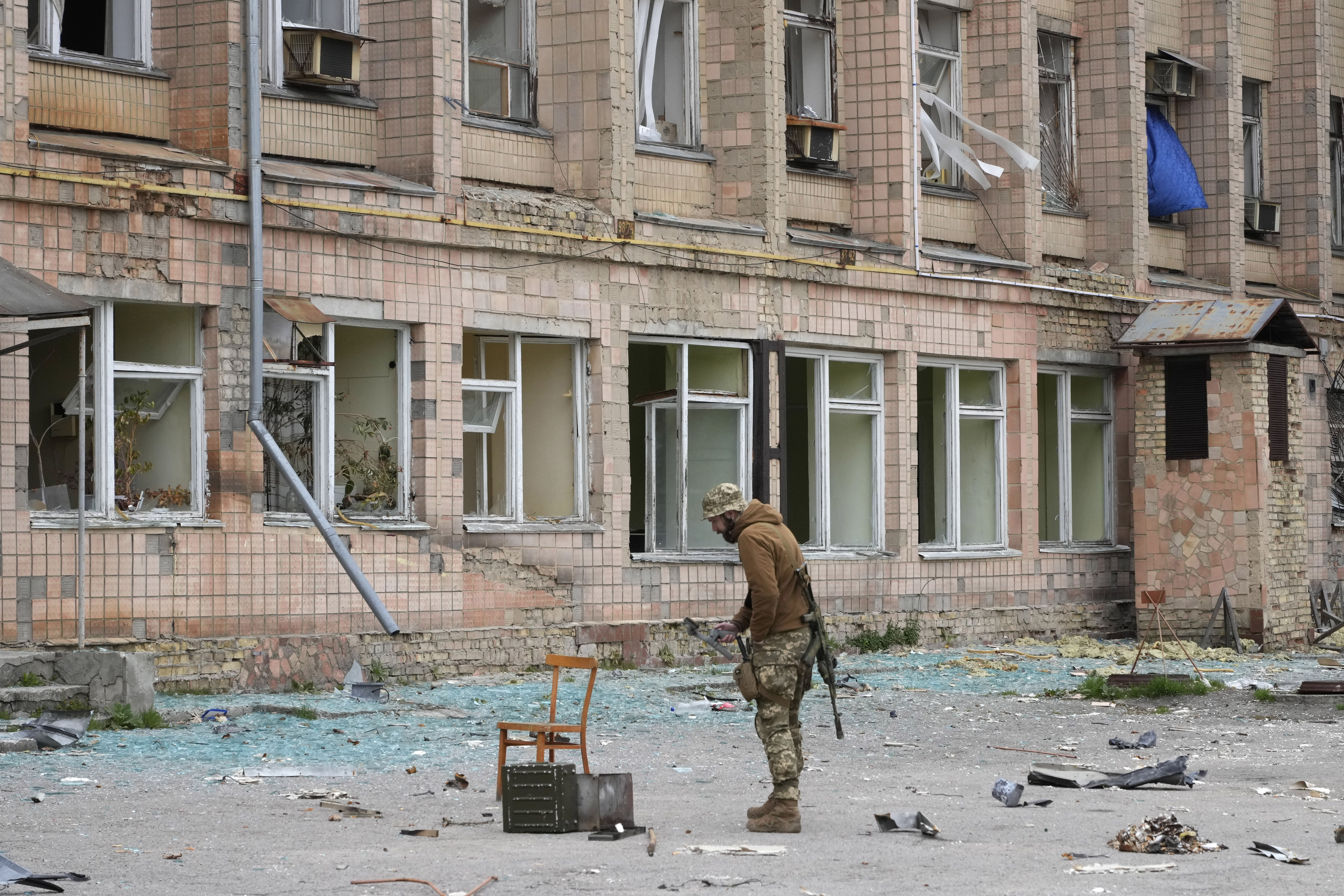 A Ukrainian soldier stands near a state-run nuclear waste department near the Chernobyl nuclear power plant, Ukraine, Saturday, April 16, 2022. (AP Photo/Efrem Lukatsky)