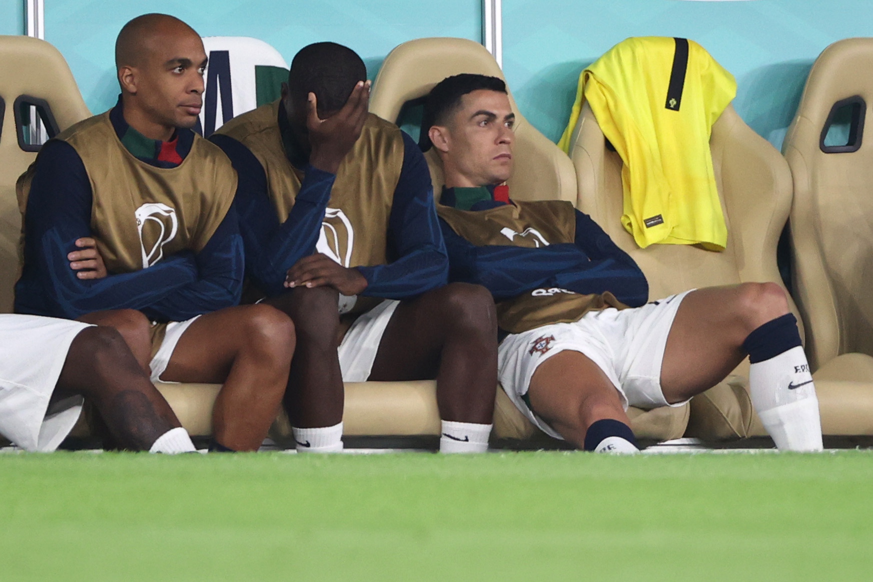 epa10359288 Cristiano Ronaldo (R) of Portugal sits on the bench during the FIFA World Cup 2022 quarter final soccer match between Morocco and Portugal at Al Thumama Stadium in Doha, Qatar, 10 December 2022.  EPA-EFE/Ali Haider