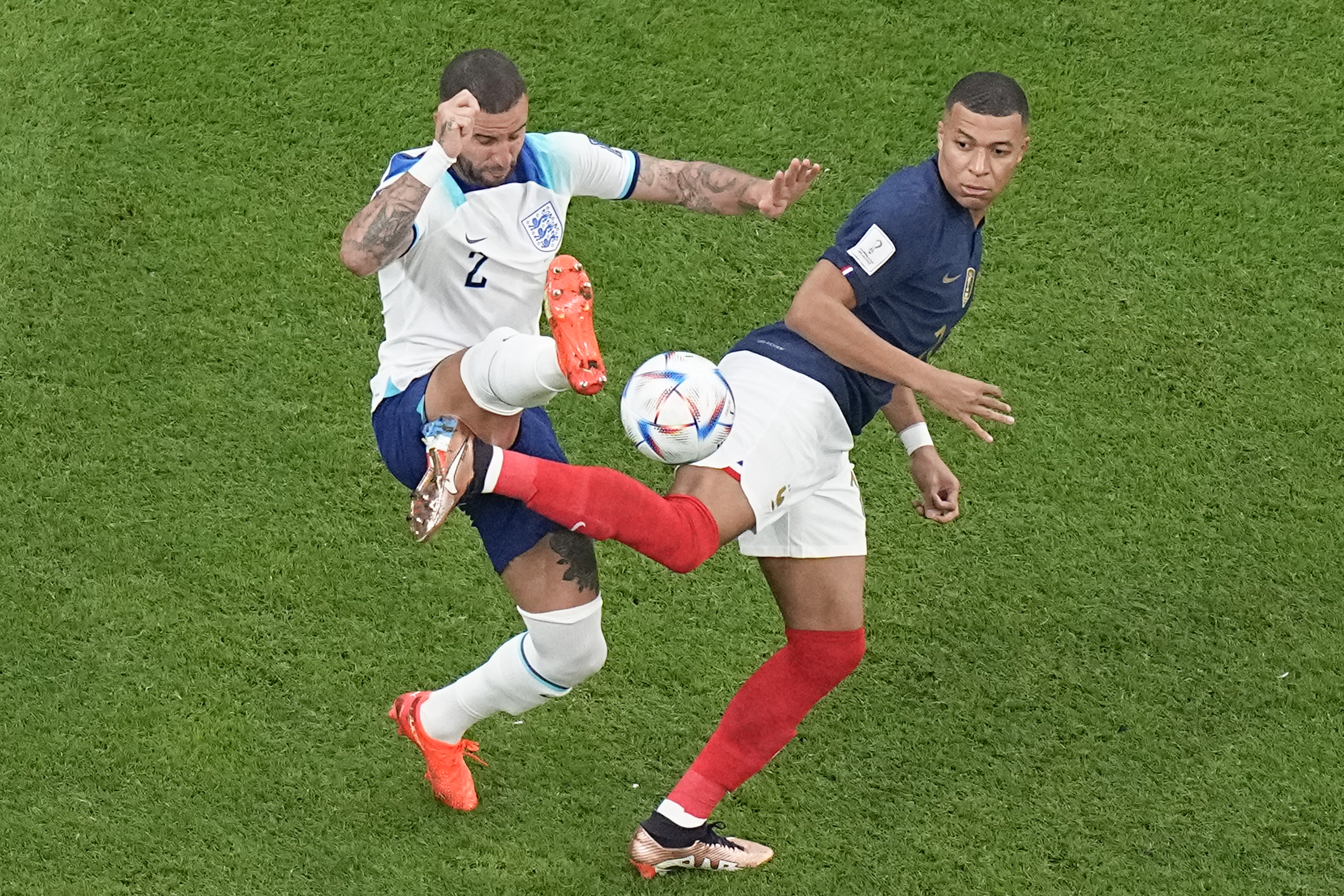 France's Kylian Mbappe, right, and England's Kyle Walker vie for the ball during the World Cup quarterfinal soccer match between England and France, at the Al Bayt Stadium in Al Khor, Qatar, Saturday, Dec. 10, 2022. (AP Photo/Pavel Golovkin)