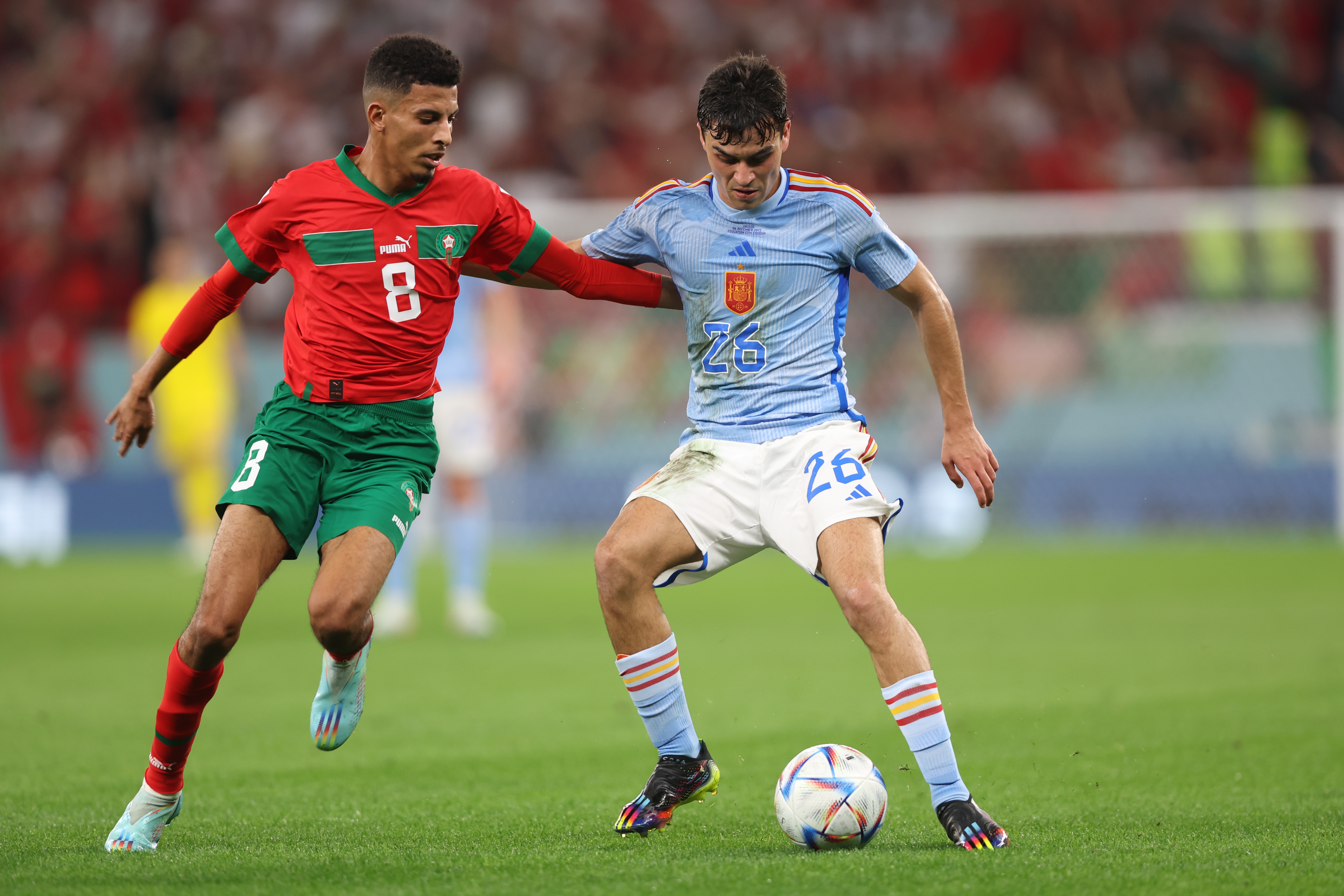 epa10352046 Azzedine Ounahi of Morocco in action against Pedri (R) of Spain during the FIFA World Cup 2022 round of 16 soccer match between Morocco and Spain at Education City Stadium in Doha, Qatar, 06 December 2022.  EPA-EFE/Tolga Bozoglu