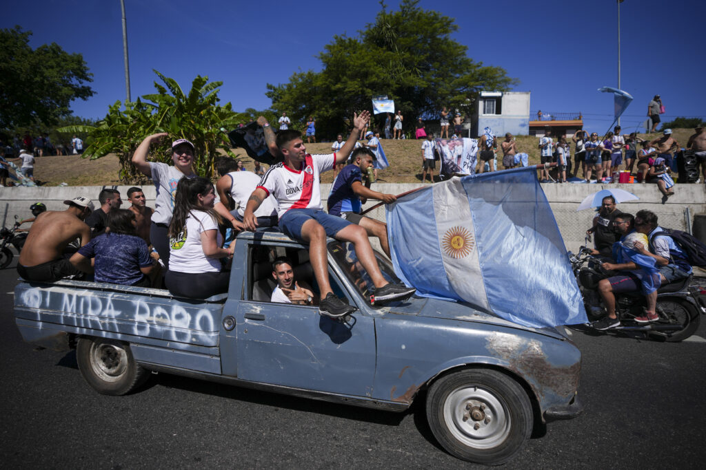Soccer fans welcome home the Argentine soccer team after it won the World Cup tournament in Buenos Aires, Argentina, Tuesday, Dec. 20, 2022. (AP Photo/Victor Caivano)