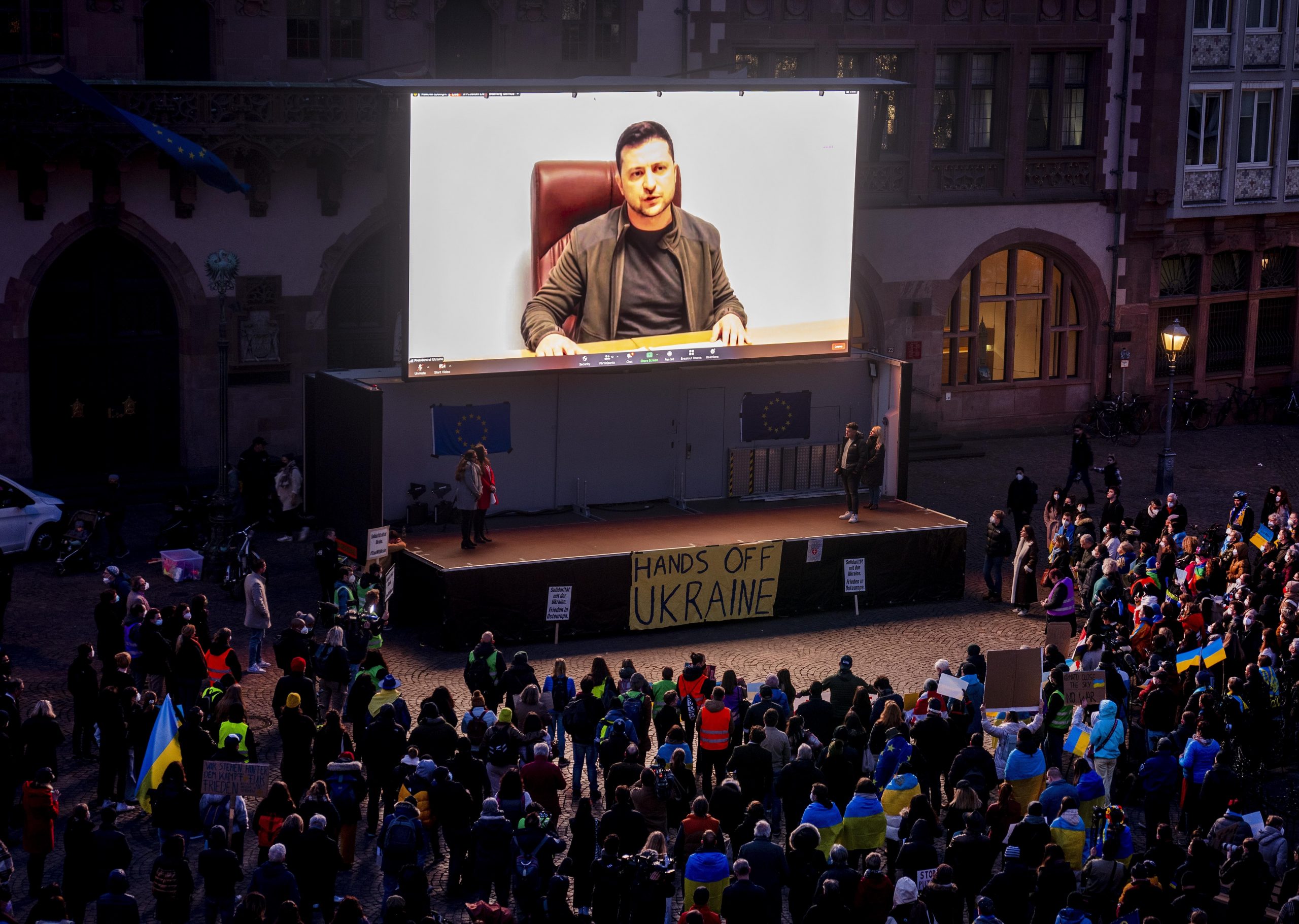 Ukrainian President Volodymyr Zelenskyy delivers a video message to the people joining a rally on the Remember square in Frankfurt, Germany, Friday, March 4, 2022. (AP Photo/Michael Probst)
