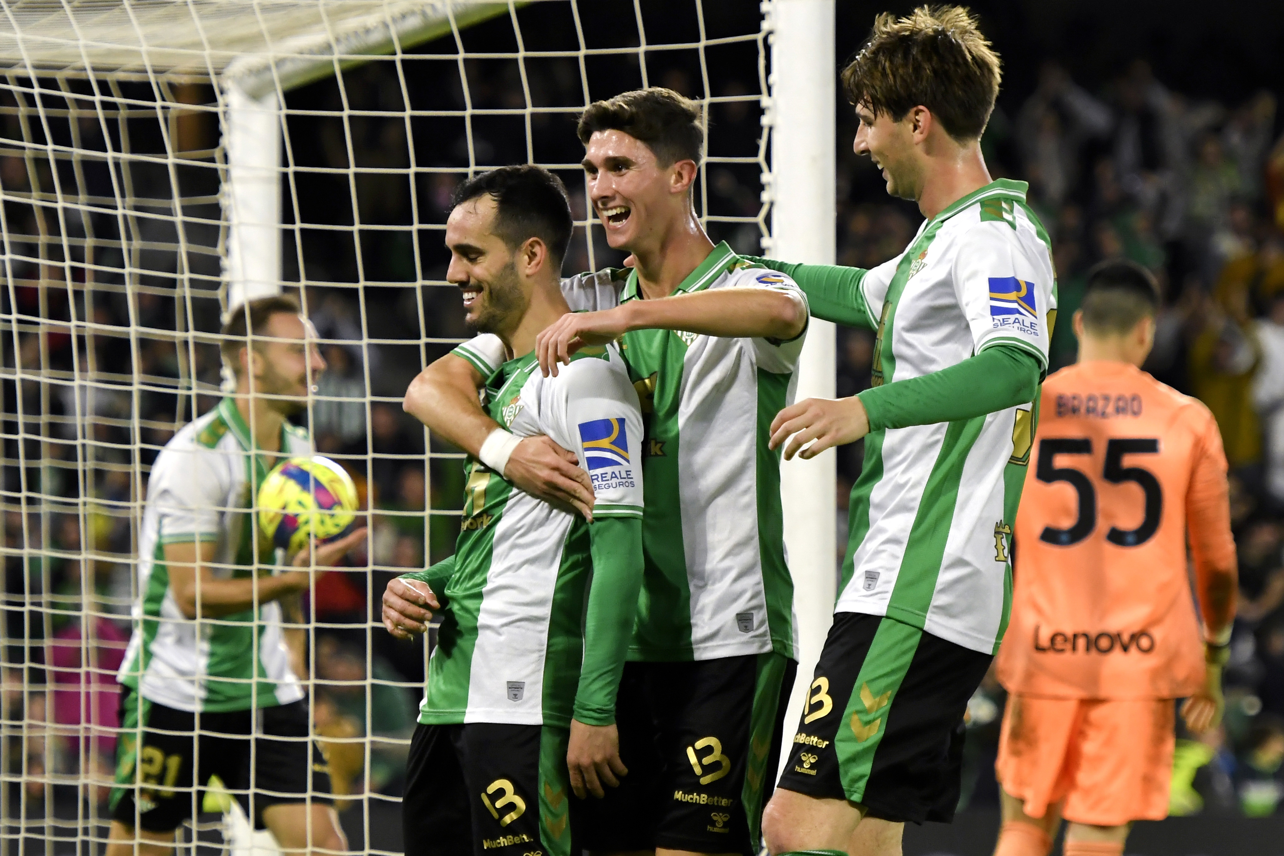 epa10370683 Betis' striker Juanmi (L) celebrates with his team-mates after scoring a goal during a friendly soccer match between Real Betis and Inter Milan at Benito Villamarin stadium in Seville, southern Spain, 17 December 2022.  EPA-EFE/Raul Caro