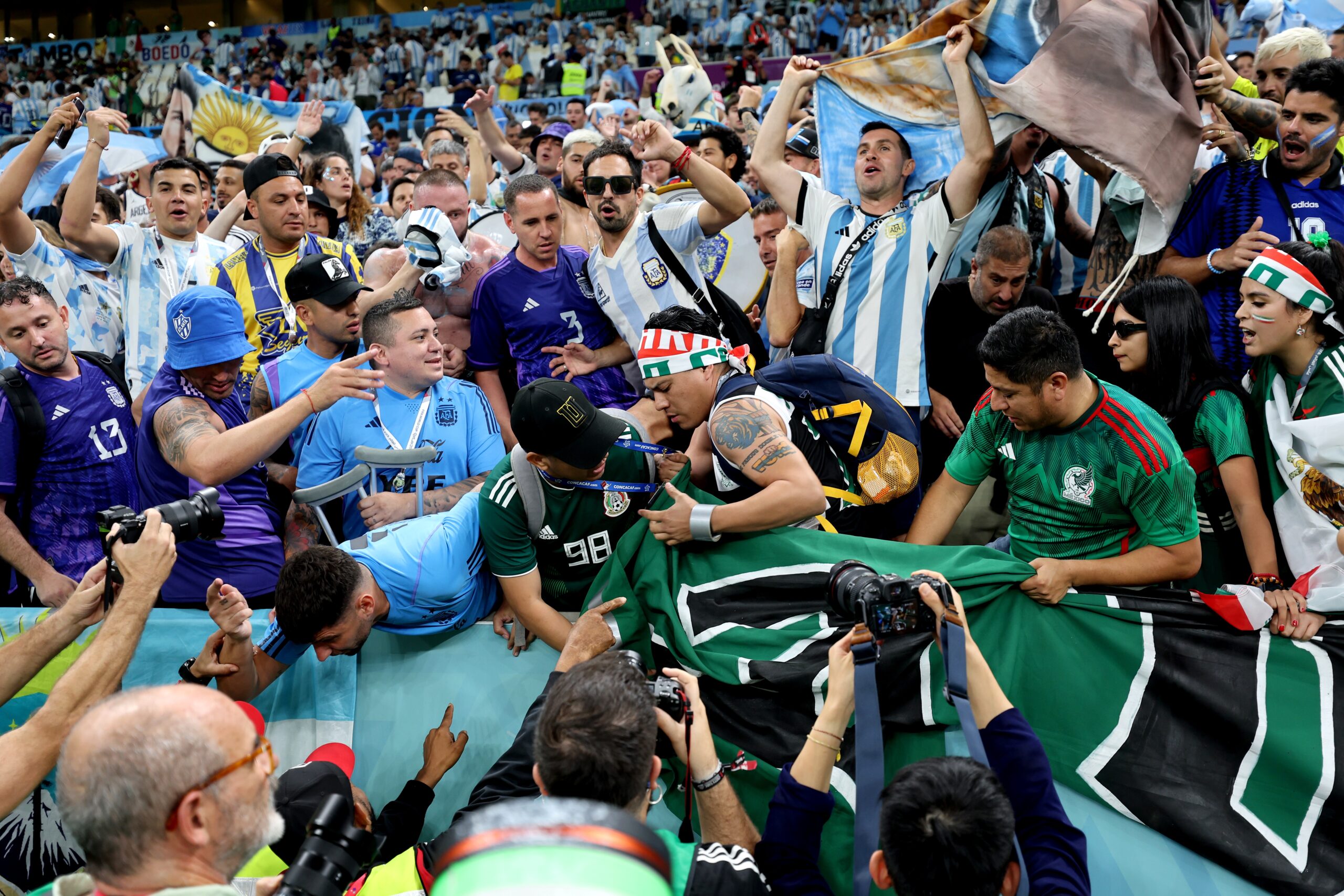epa10330878 Fans of Argentina (blue) encounter in the stands with fans of Mexico (green) before the FIFA World Cup 2022 group C soccer match between Argentina and Mexico at Lusail Stadium in Lusail, Qatar, 26 November 2022.  EPA-EFE/Mohamed Messara