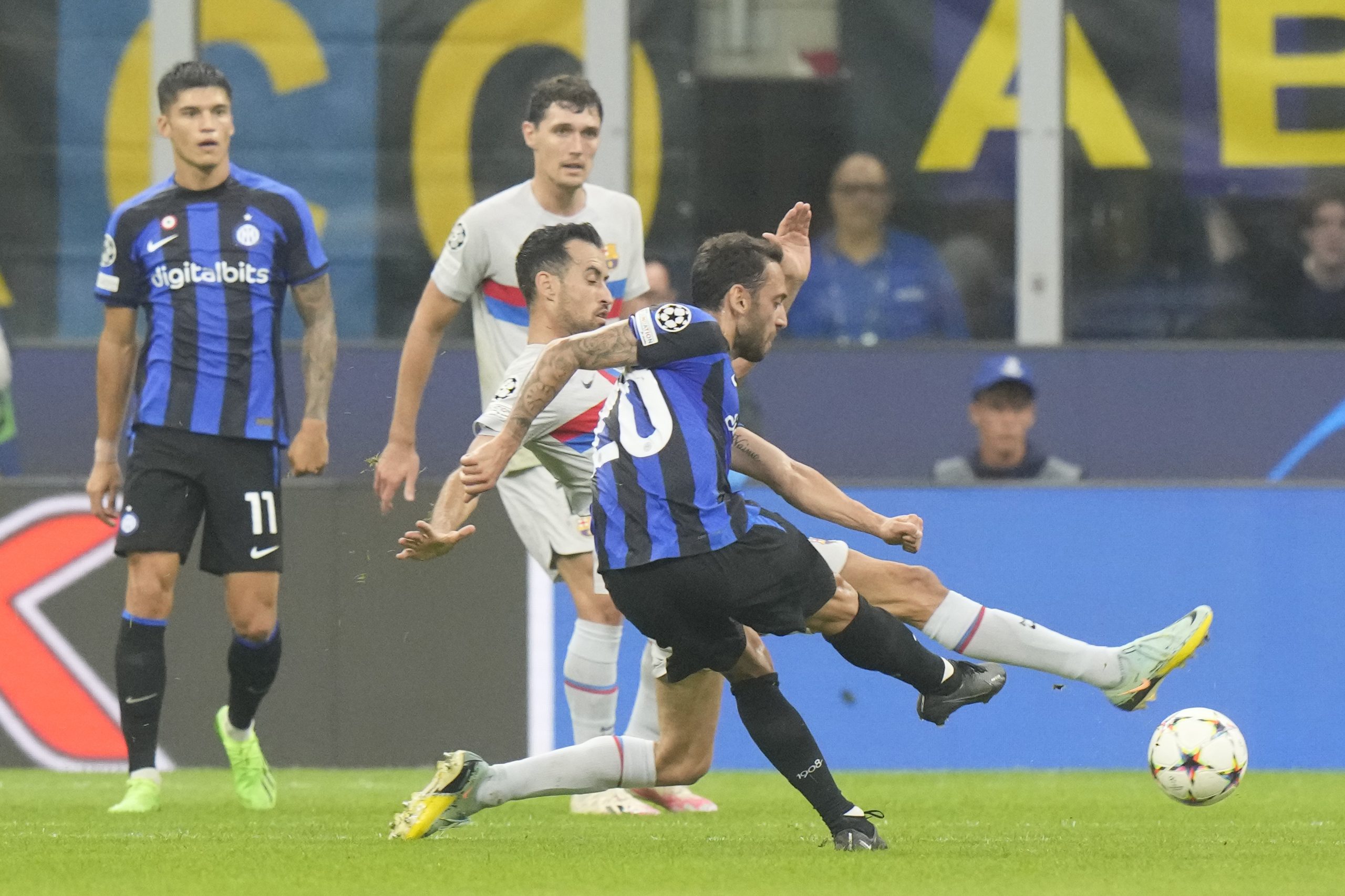 Inter Milan's Hakan Calhanoglu, right, scores his side's opening goal during the Champions League group C soccer match between Inter Milan and Barcelona at the San Siro stadium in Milan, Italy, Tuesday, Oct. 4, 2022. (AP Photo/Luca Bruno)