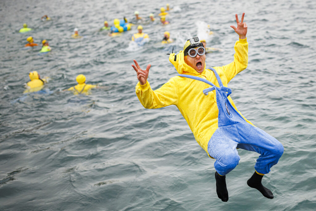 A participant of the 84th edition of the annual Christmas swimming "Coupe de Noel" jumps into Lake Geneva (lac Leman), in Geneva, Switzerland, Saturday, Dec. 17, 2022. (Valentin Flauraud/Keystone via AP)