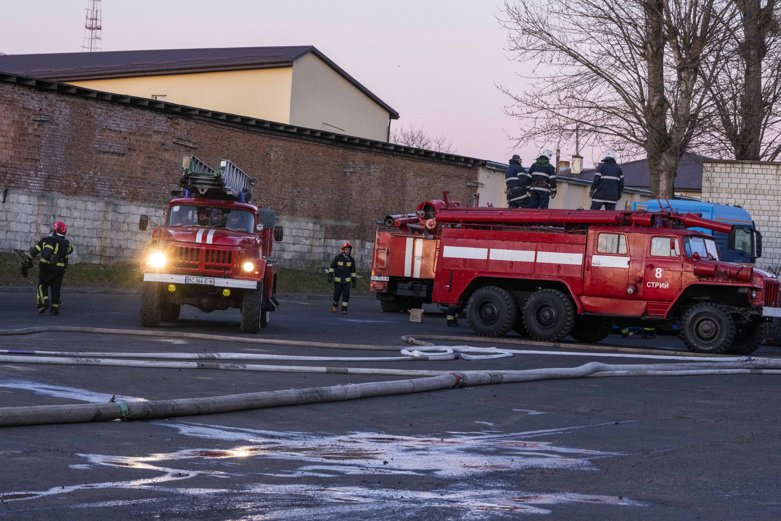 Firefighters work at the site in the aftermath of the first strike that involved Russian rockets that hit an oil facility in an industrial area in the northeastern outskirts of Lviv, Ukraine, Sunday, March 27, 2022. (AP Photo/Nariman El-Mofty)