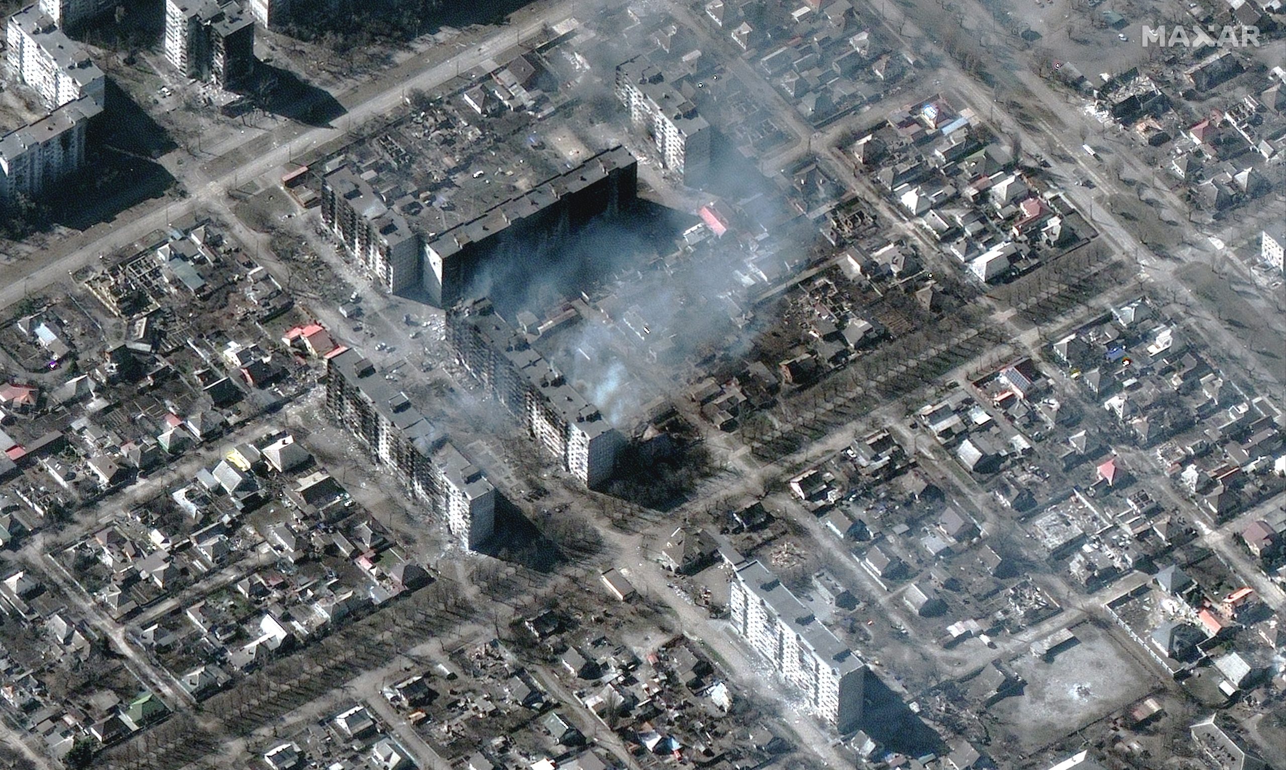 This satellite image provided by Maxar Technologies shows burning and destroyed apartment buildings in Mariupol, Ukraine Tuesday, March 22, 2022. (Satellite image ©2022 Maxar Technologies via AP)