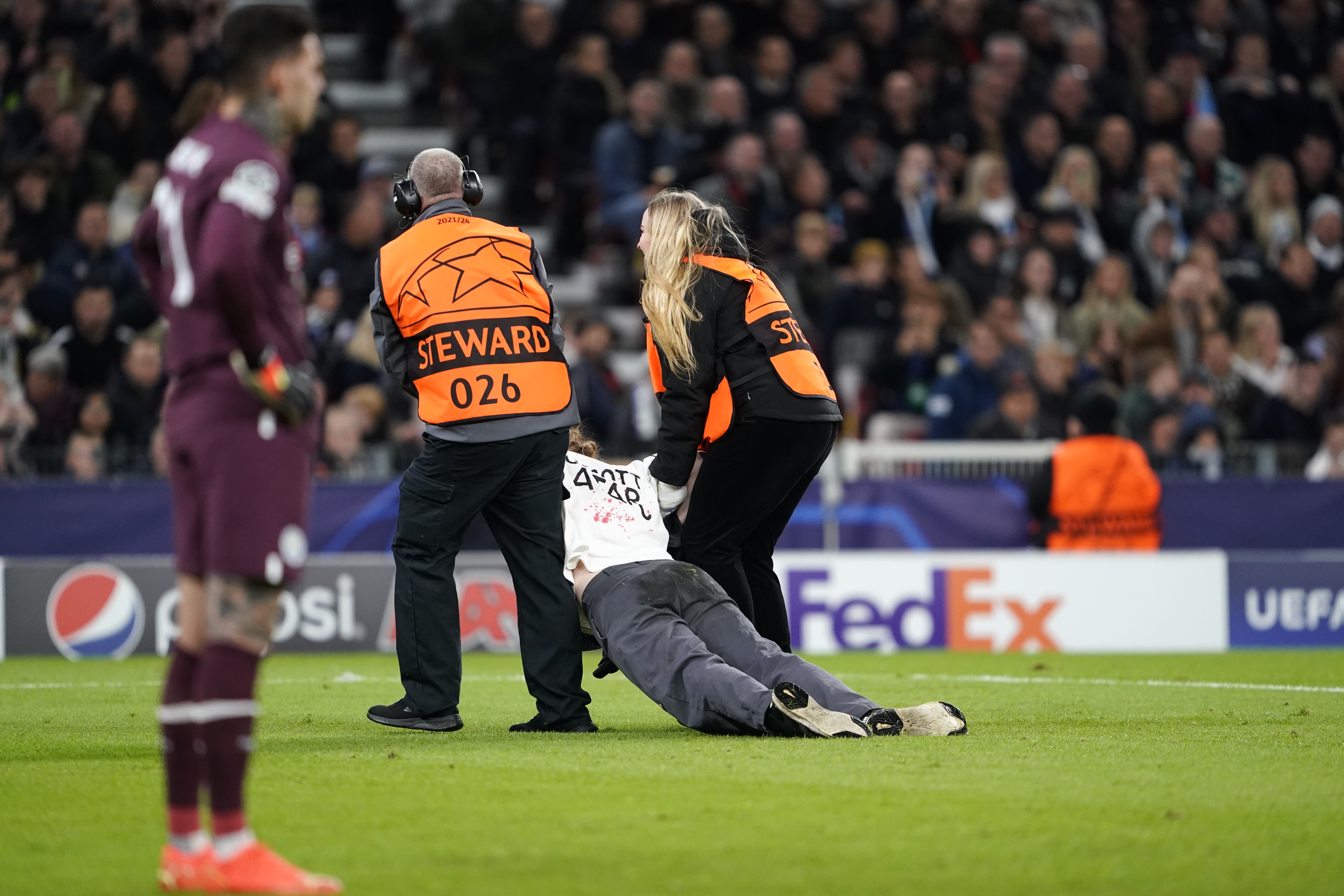 epa10236551 A protester wearing a 'Boycott Qatar' shirt is carried off the pitch during the group G Champions League soccer match between FC Copenhagen and Manchester City FC in Copenhagen, Denmark, 11 October 2022.  EPA-EFE/Liselotte Sabroe  DENMARK OUT