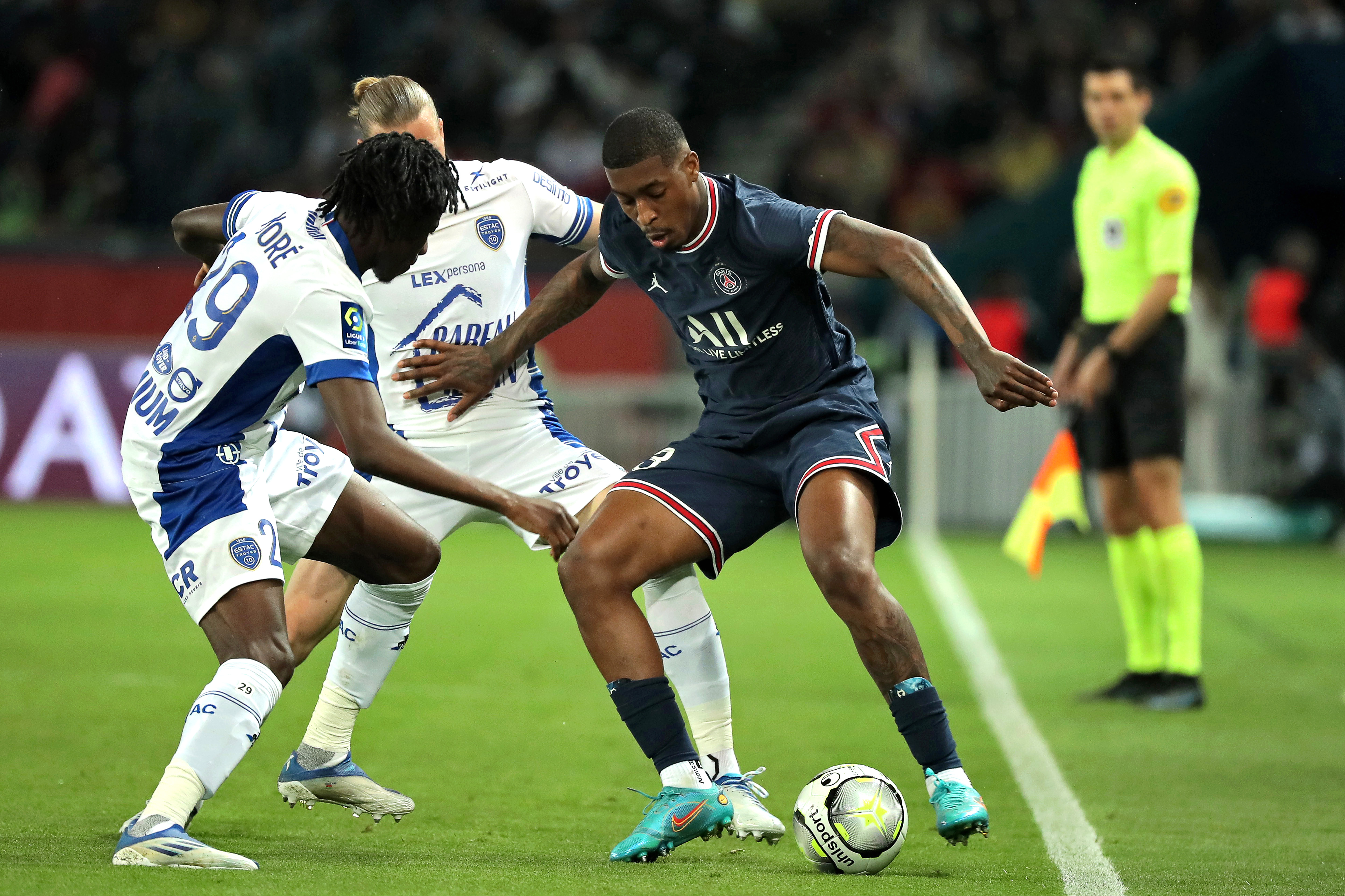 epa09934648 Paris Saint-Germain's Presnel Kimpembe (R) in action against Issa Kabore (L) of Troyes during the French Ligue 1 soccer match between Paris Saint-Germain (PSG) and ES Troyes AC in Paris, France, 08 May 2022.  EPA-EFE/CHRISTOPHE PETIT TESSON