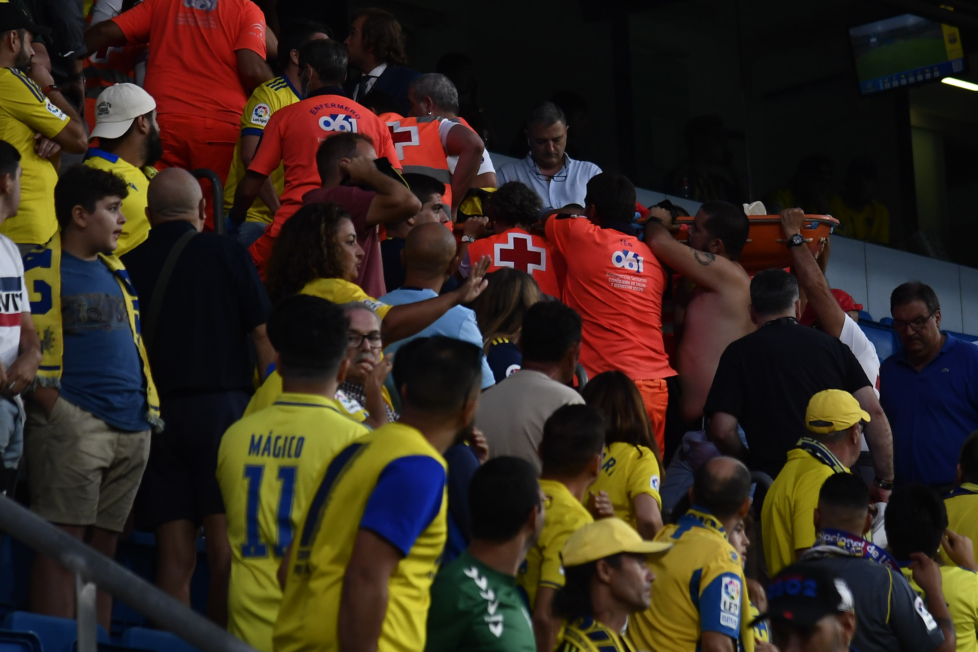 A person is carried in a stretcher out of the stadium by Red Cross members during Spanish la Liga soccer match between Cadiz FC and FC Barcelona at the Nuevo Mirandilla stadium in Cadiz, southern Spain, Saturday, Sept. 10, 2022. (AP Photo/Jose Breton)