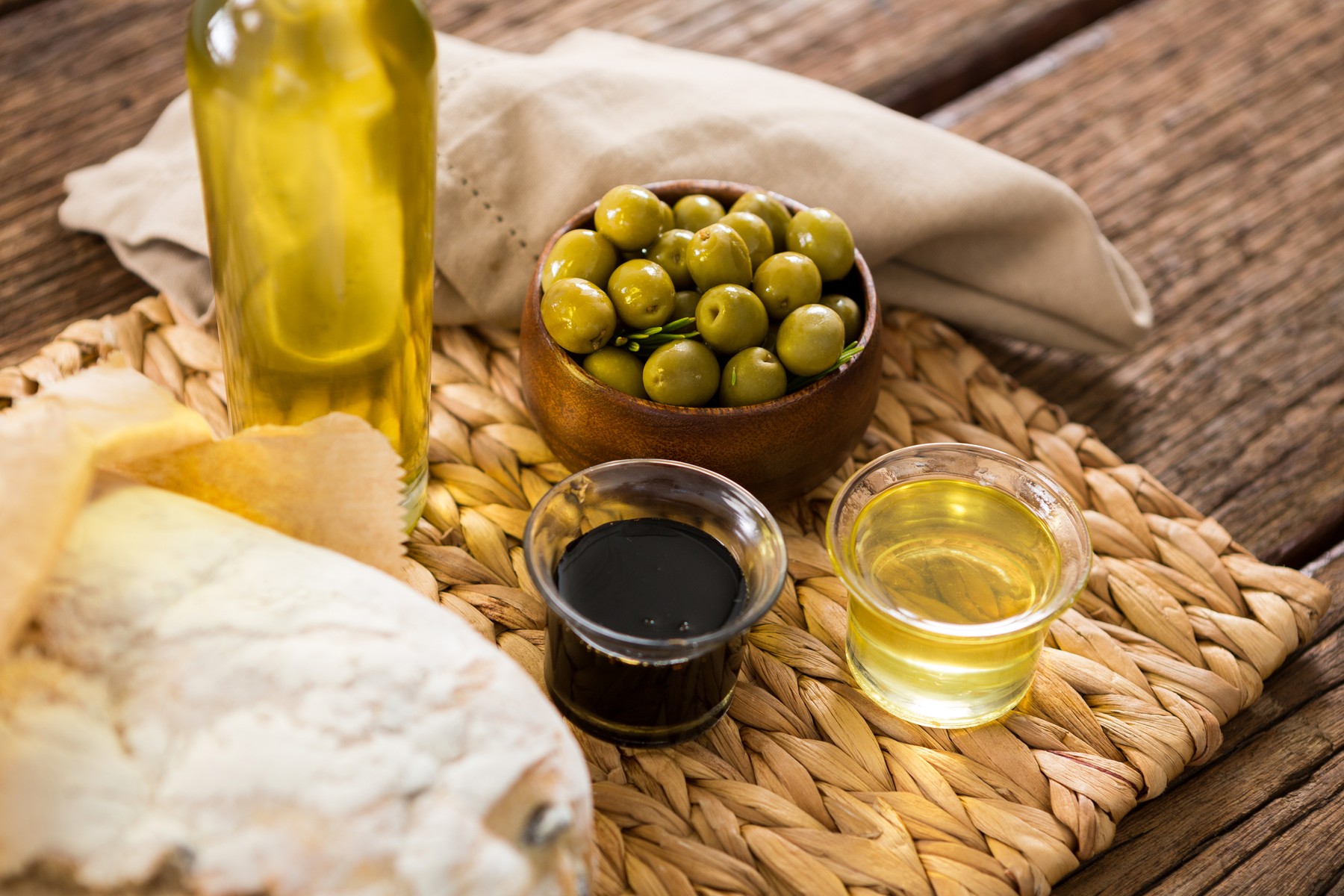 Close-up of marinated olives and oil bottle on wooden table,Image: 341144387, License: Rights-managed, Restrictions: , Model Release: yes, Credit line: - / Wavebreak / Profimedia