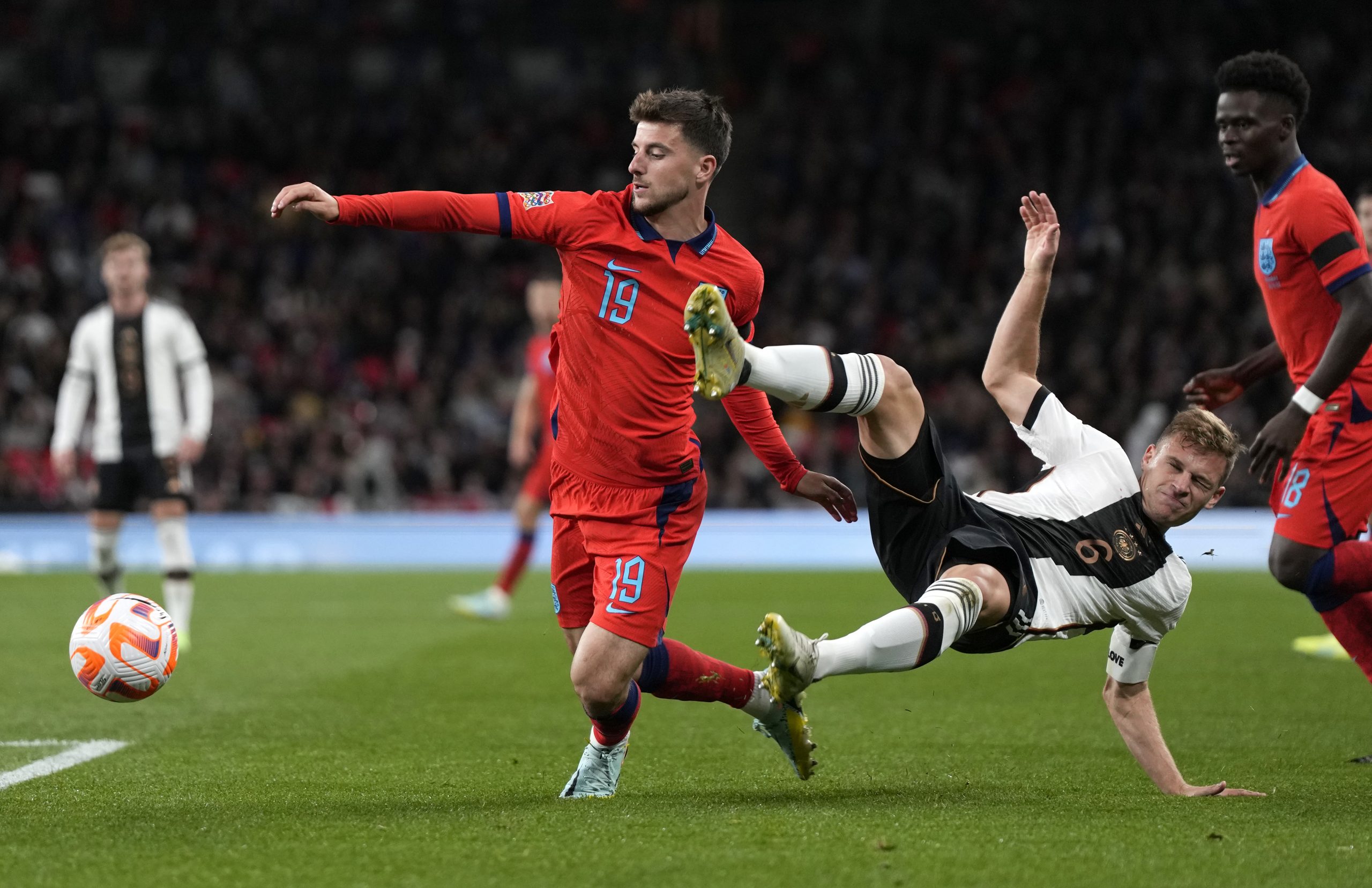 England's Mason Mount, left, challenges for the ball with Germany's Joshua Kimmich during the UEFA Nations League soccer match between England and Germany at the Wembley Stadium in London, England, Monday, Sept. 26, 2022. (AP Photo/Alastair Grant)