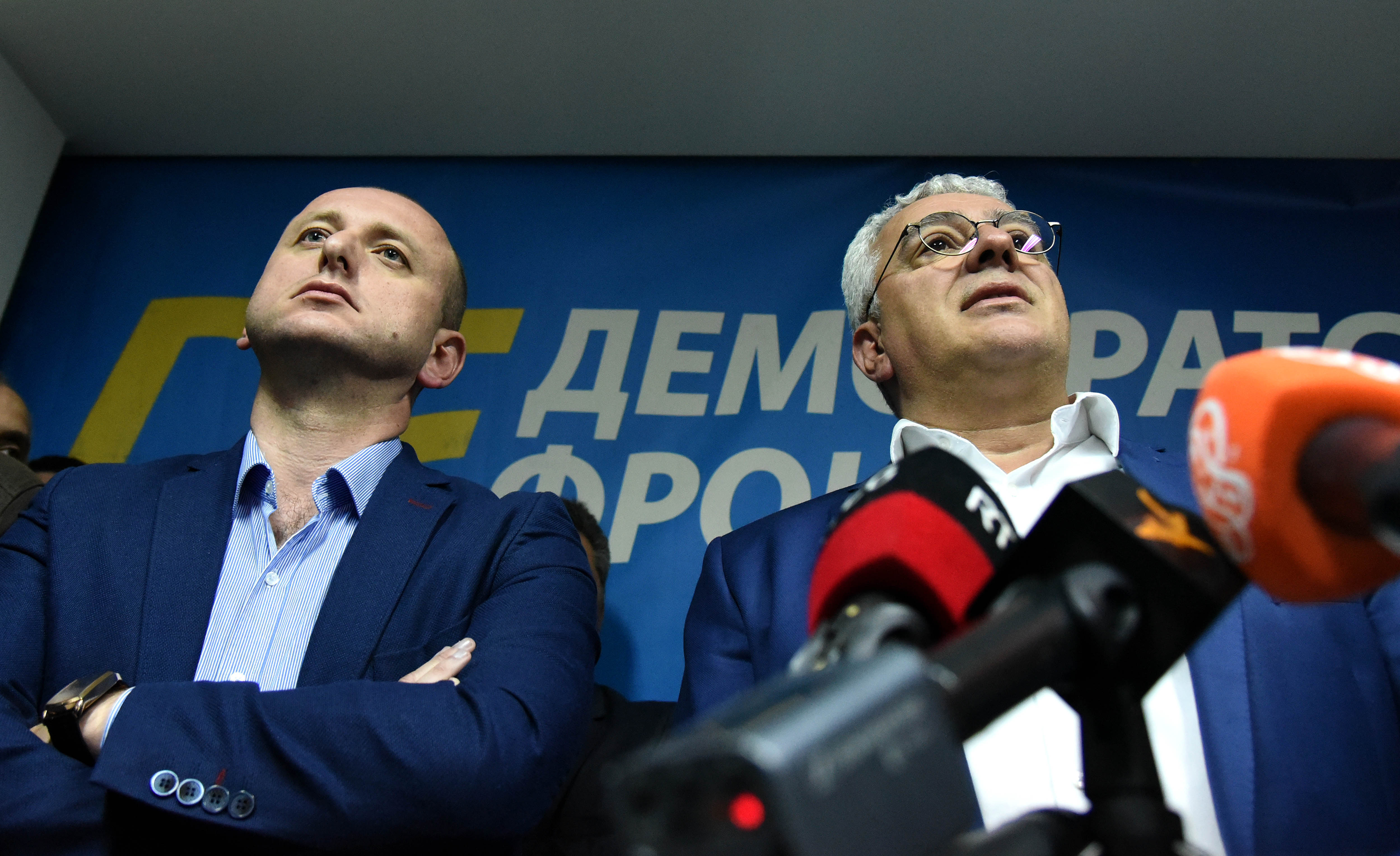 Two Russian intelligence officers and two opposition politicians were among 13 people sentenced