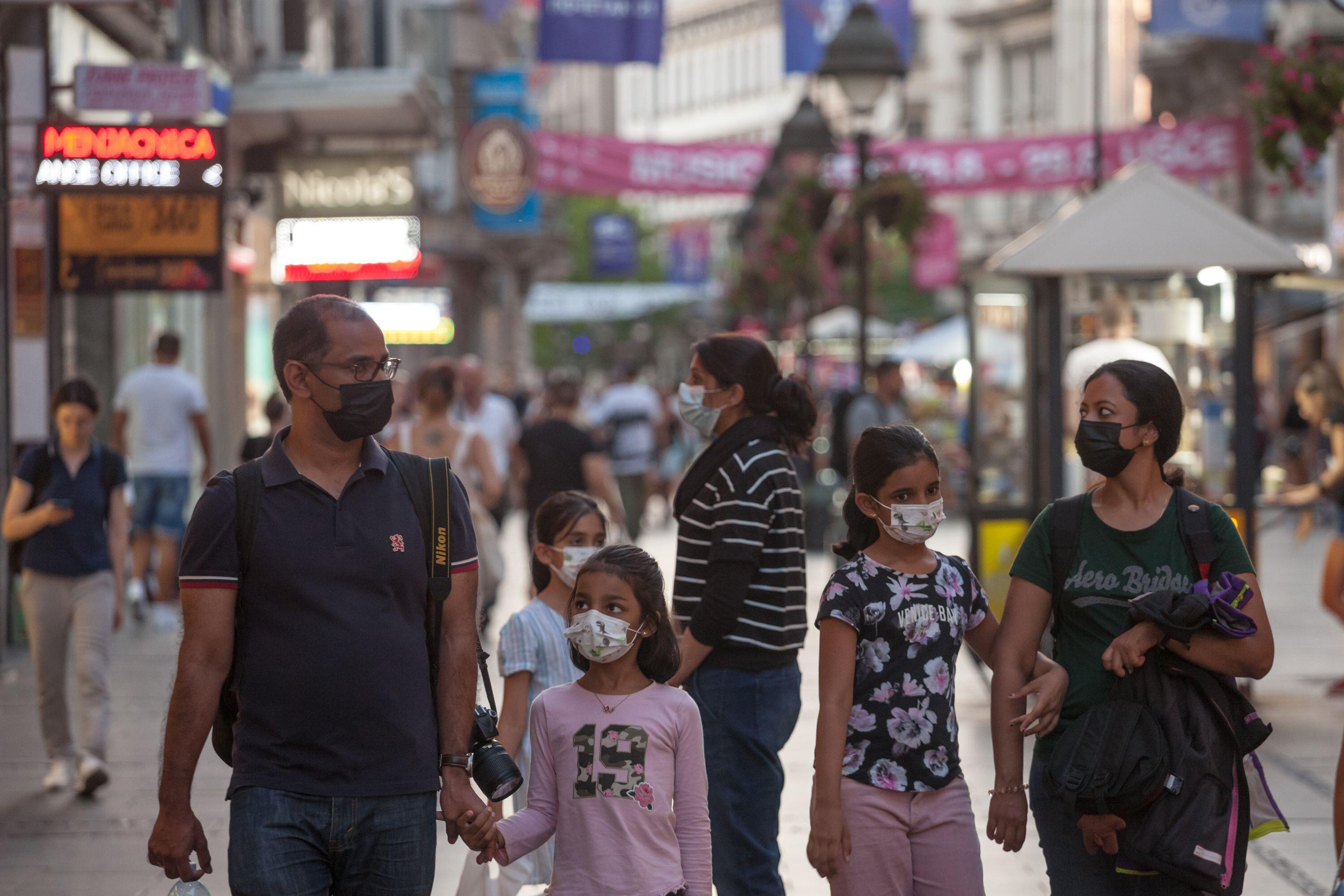 Picture of a indian family standing in the streets of Belgrade, Serbia, while wearing a protective face mask, during the 2020 2021 coronavirus covid 1