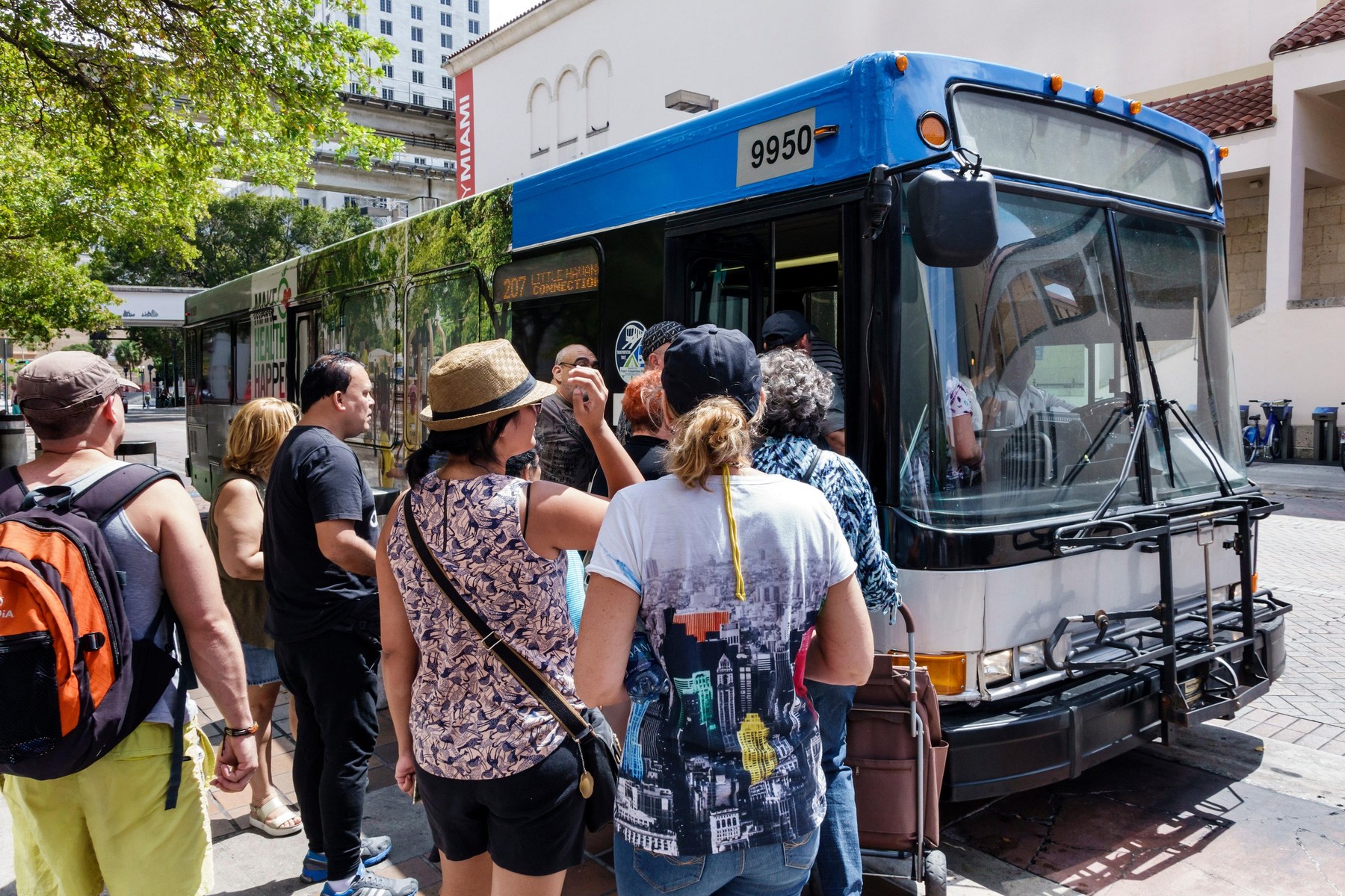 Miami Florida,Miami-Dade Metrobus,public transportation,bus stop,riders,passenger passengers rider riders,boarding,adult,adults,man men male,woman wom