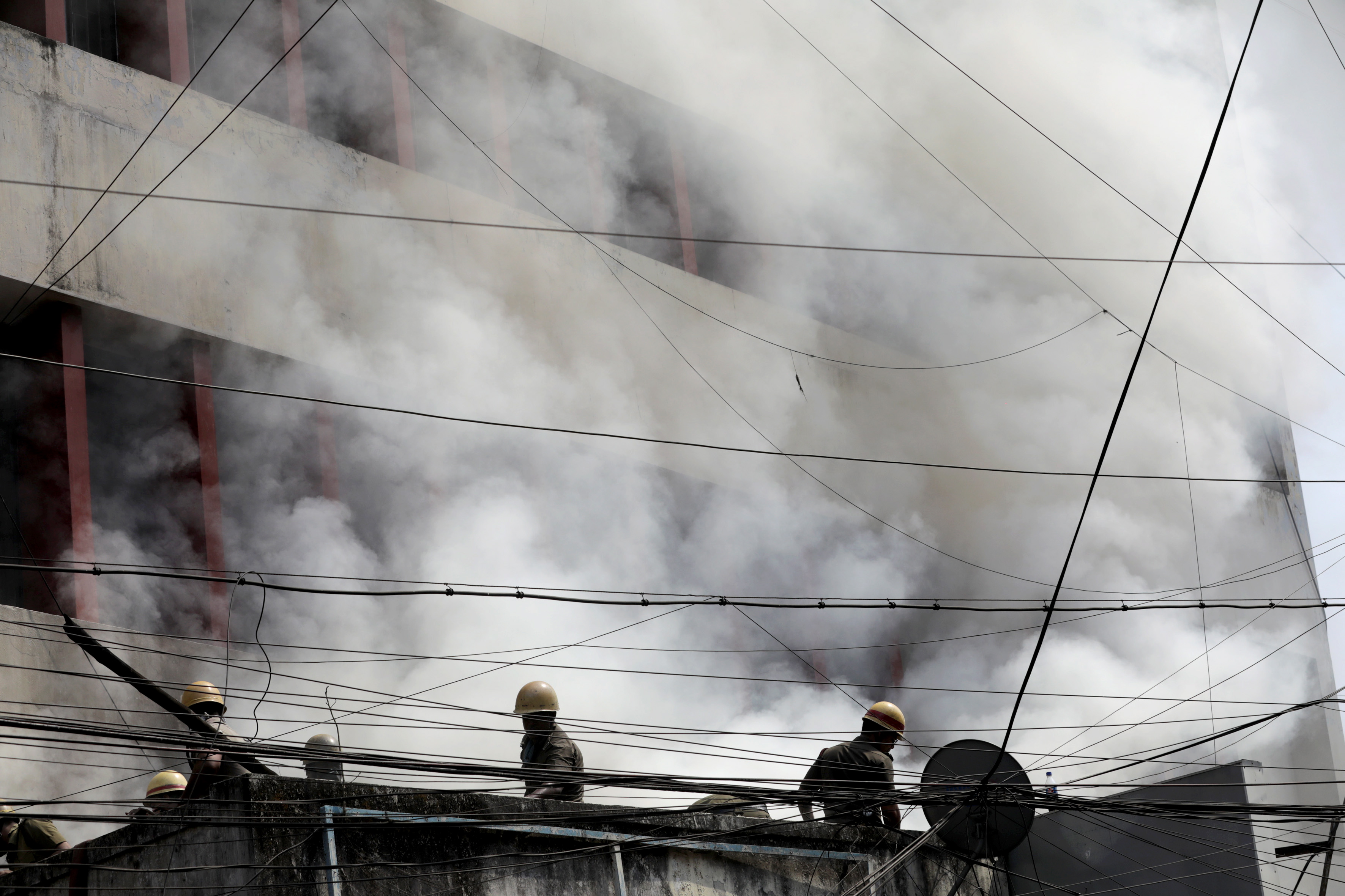 Firefighters battle a large fire at a market .