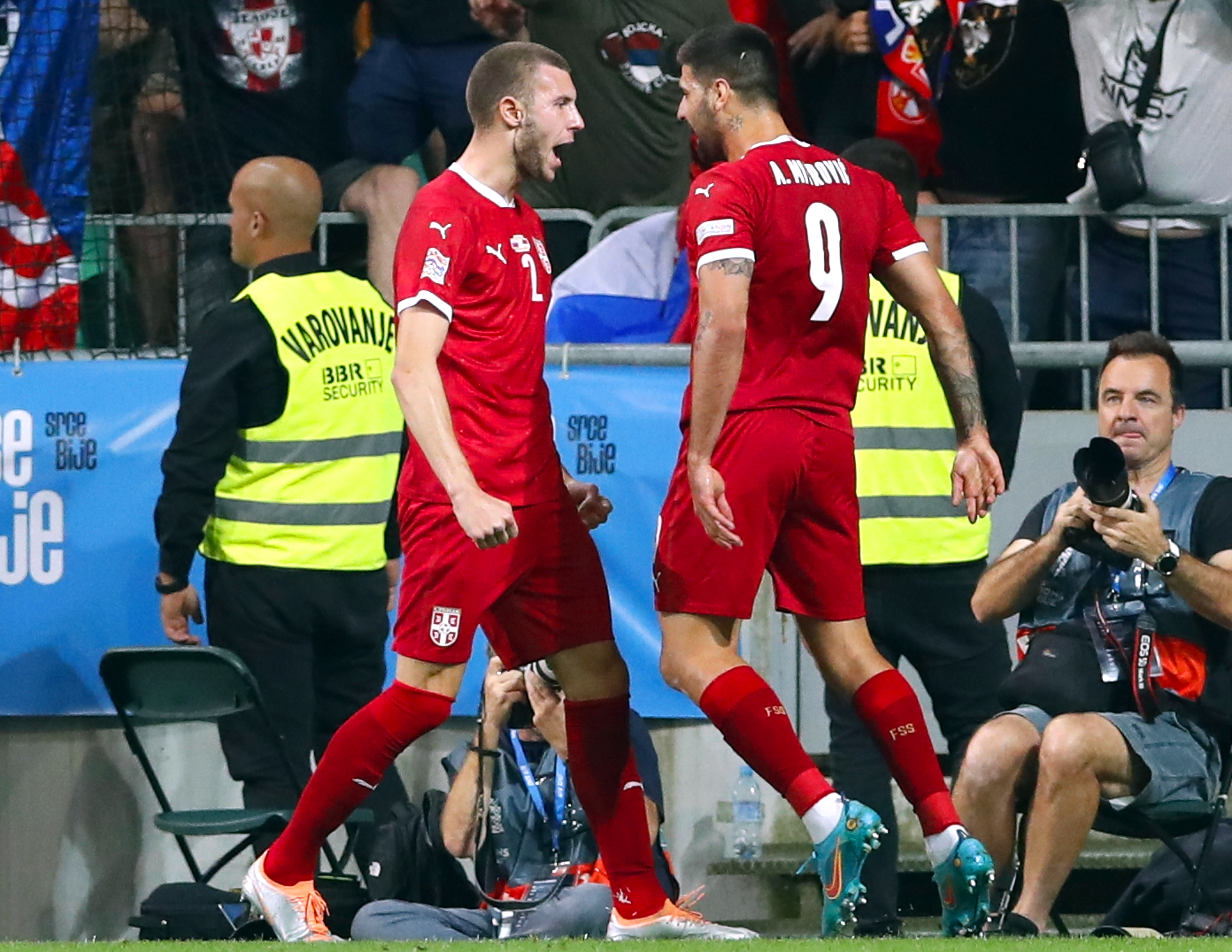 epa10009993 Aleksandar Mitrovic (R) of Serbia celebrates with teammate Strahinja Pavlovic (L) after scoring the 2-0 lead during the UEFA Nations League soccer match between Slovenia and Serbia in Ljubljana, Slovenia, 12 June 2022.  EPA-EFE/ANTONIO BAT