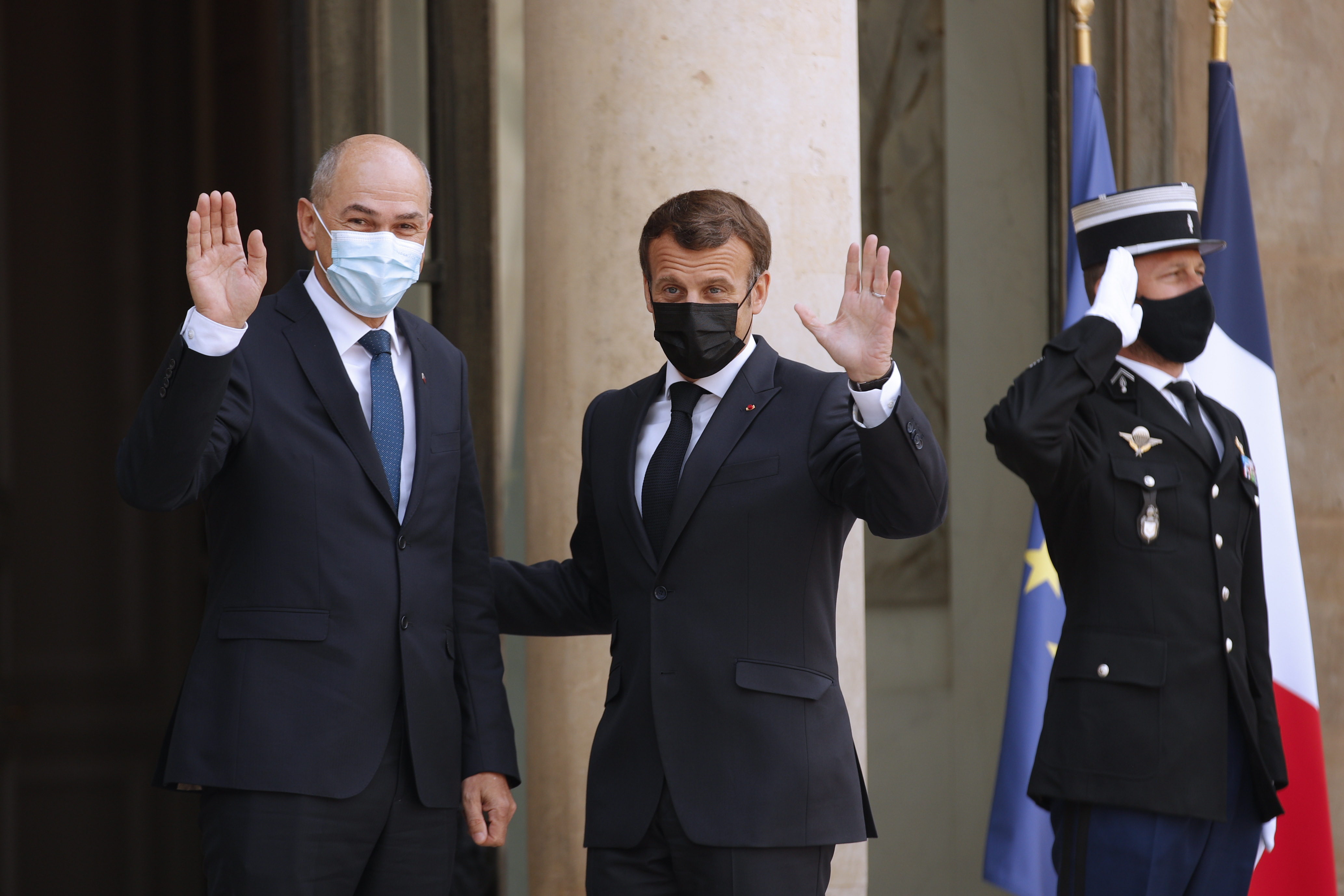 epa09167624 French President Emmanuel Macron (C) greets Slovenian Prime Minister Janez Jansa (L) upon his arrival at the Elysee Palace in Paris, France, 29 April 2021.  EPA-EFE/YOAN VALAT