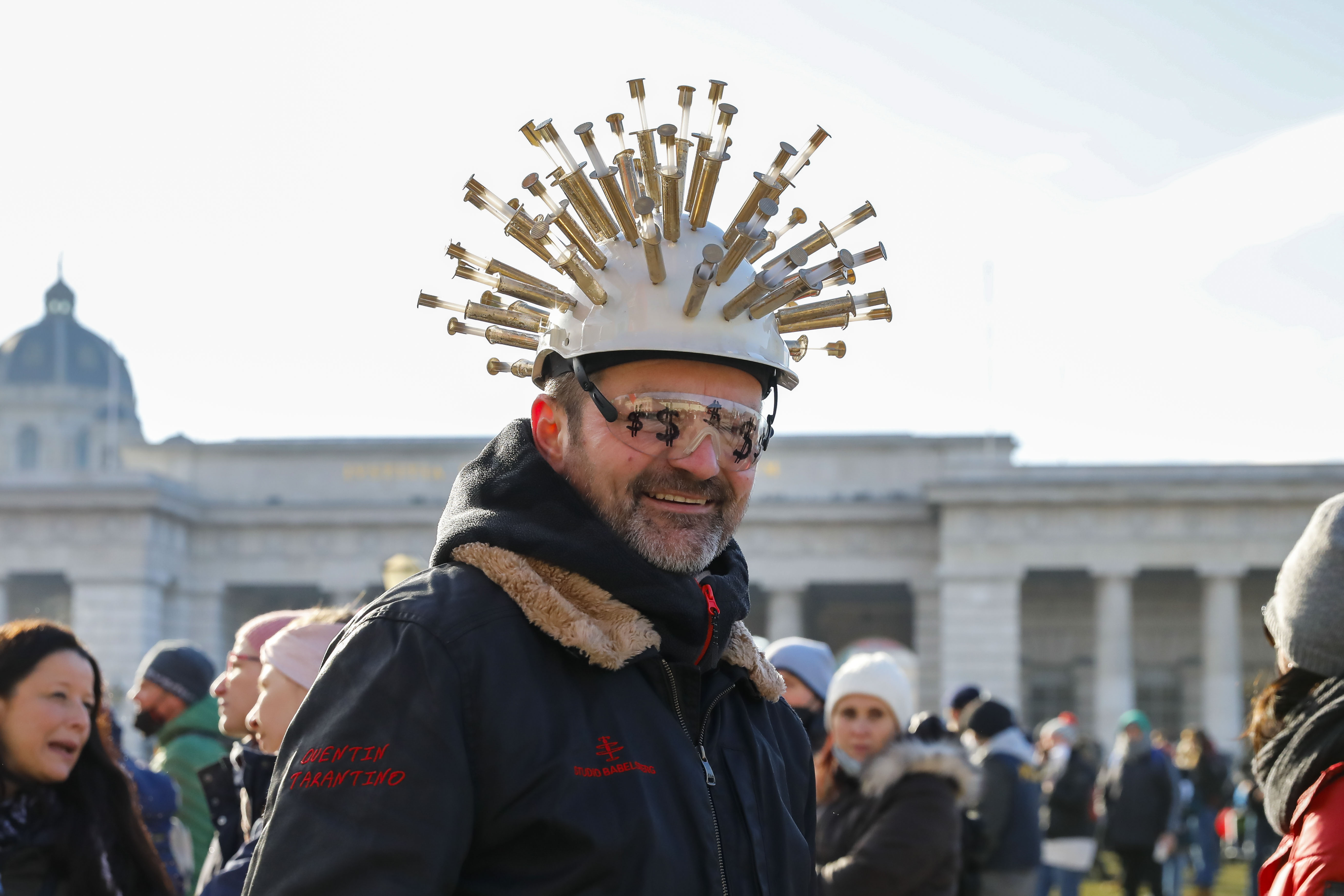A person, wearing a helmet with many needles on it, poses for a photo and takes part in a demonstration against the country's coronavirus restrictions in Vienna, Austria, Saturday, Jan. 8, 2022. (AP Photo/Lisa Leutner)