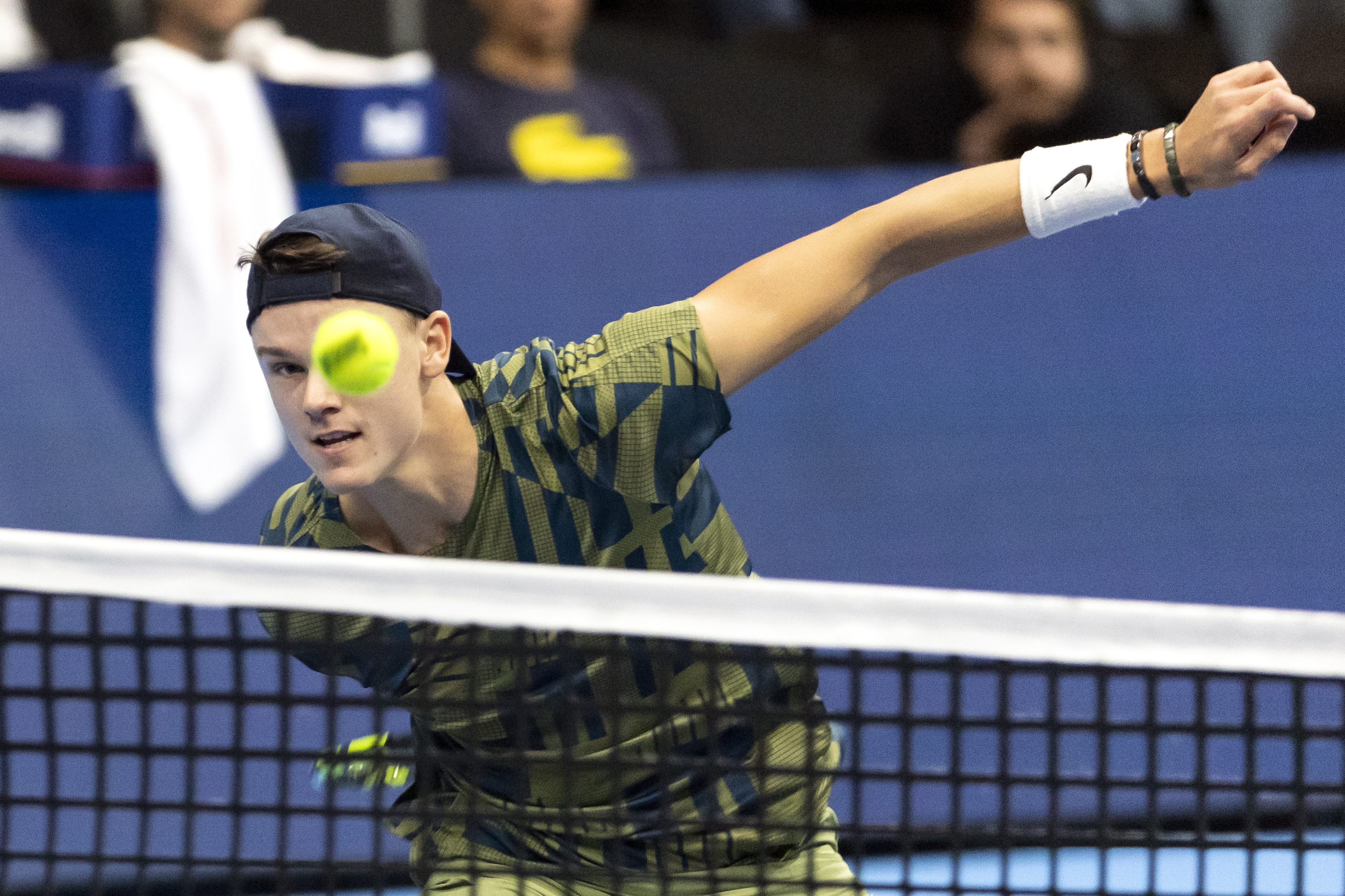 epa10275273 Holger Rune of Denmark returns a ball to Felix Auger-Aliassime of Canada during the final match at the Swiss Indoors tennis tournament in Basel, Switzerland, 30 October 2022.  EPA-EFE/ALEXANDRA WEY