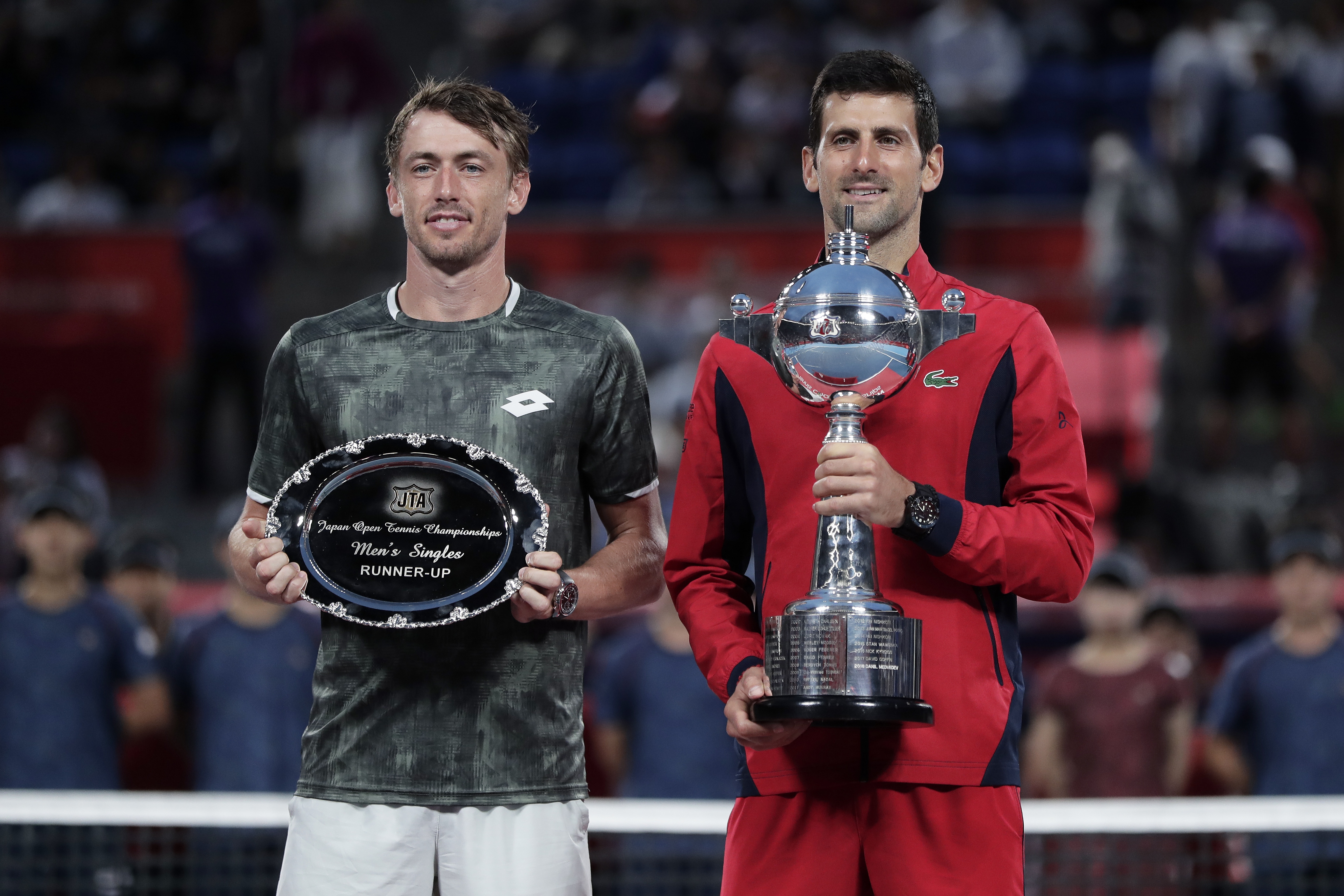 epa07900677 Winner Novak Djokovic (R) of Serbia and runner-up John Millman (L) of Australia pose with their trophies after the men's singles final match at the Japan Open Tennis Championships in Tokyo, Japan, 06 October 2019.  EPA-EFE/KIYOSHI OTA