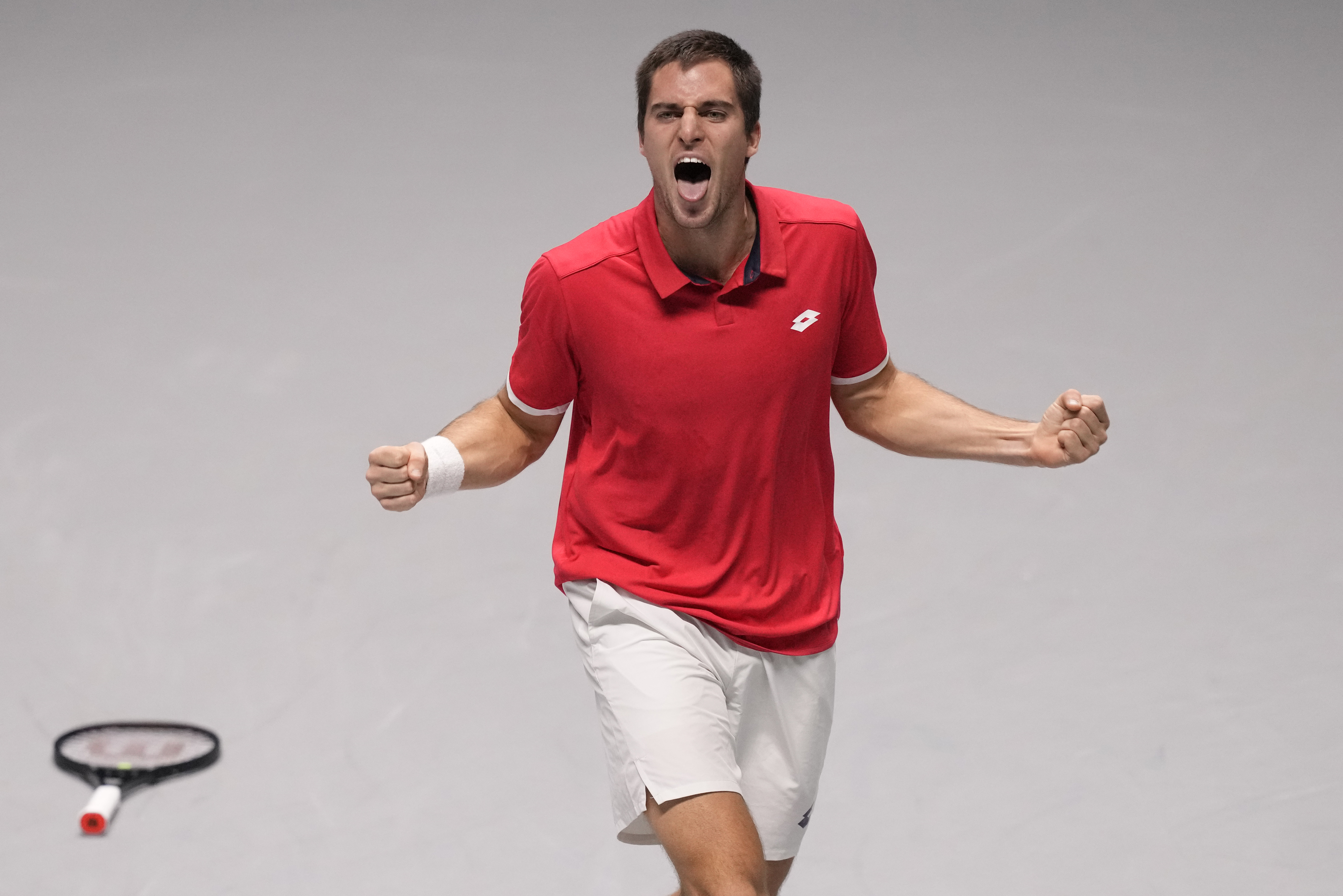 Croatia's Borna Gojo celebrates after winning against Italy's Lorenzo Sonego during their Davis Cup men's single Finals tennis match at the Pala Alpitour in Turin, Italy, Monday, Nov. 29, 2021. (AP Photo/Antonio Calanni)