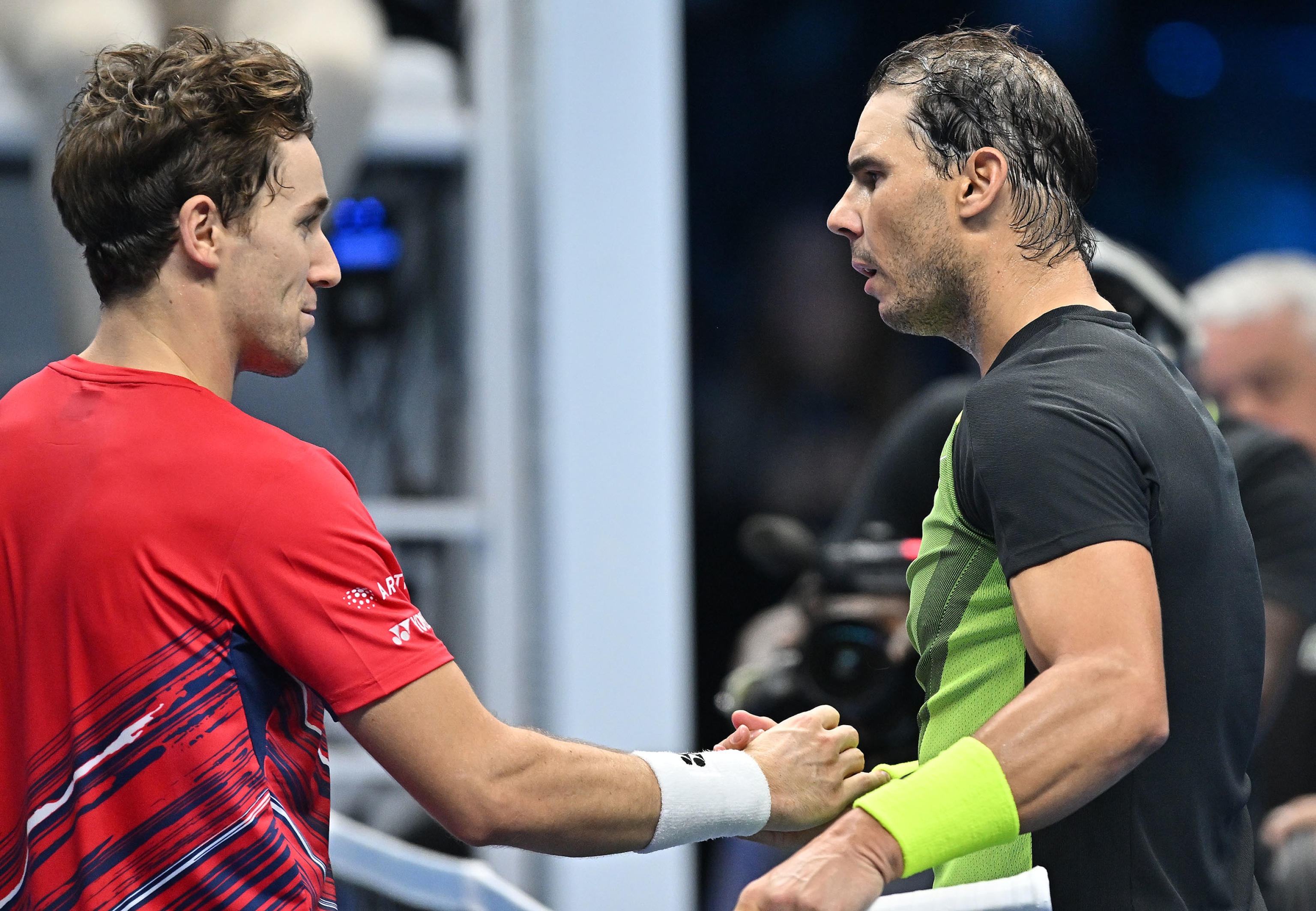 epa10310543 Rafael Nadal (R) of Spain is congratulated by Casper Ruud (L) of Norway after winning their group match at the Nitto ATP Finals 2022 tennis tournament at the Pala Alpitour arena in Turin, Italy, 17 November 2022.  EPA-EFE/Alessandro Di Marco